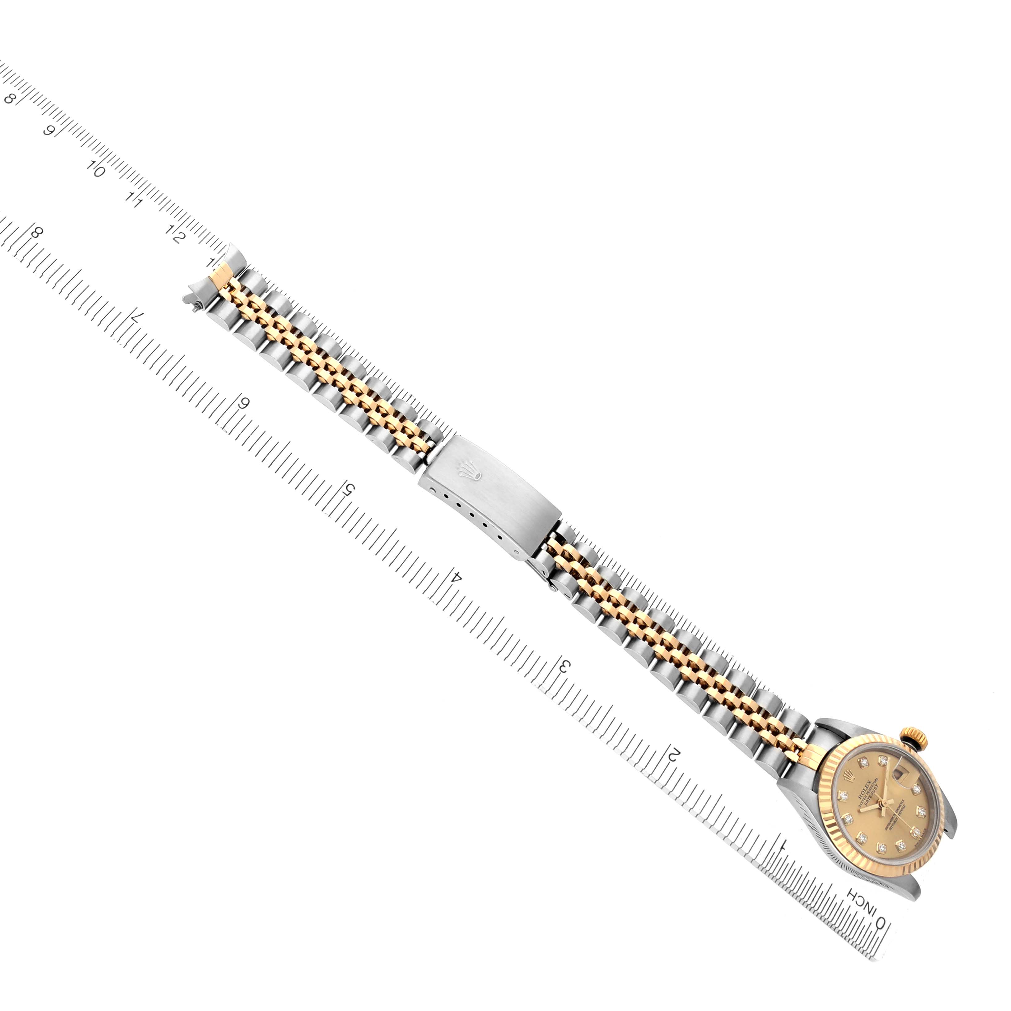 The image shows a Rolex Datejust 79173 Women's Steel and Gold (two tone) Champagne Dial 79173 Women's Steel and Gold (two tone) Champagne Dial watch at an angle displaying the bracelet and clasp, with a ruler alongside for scale.