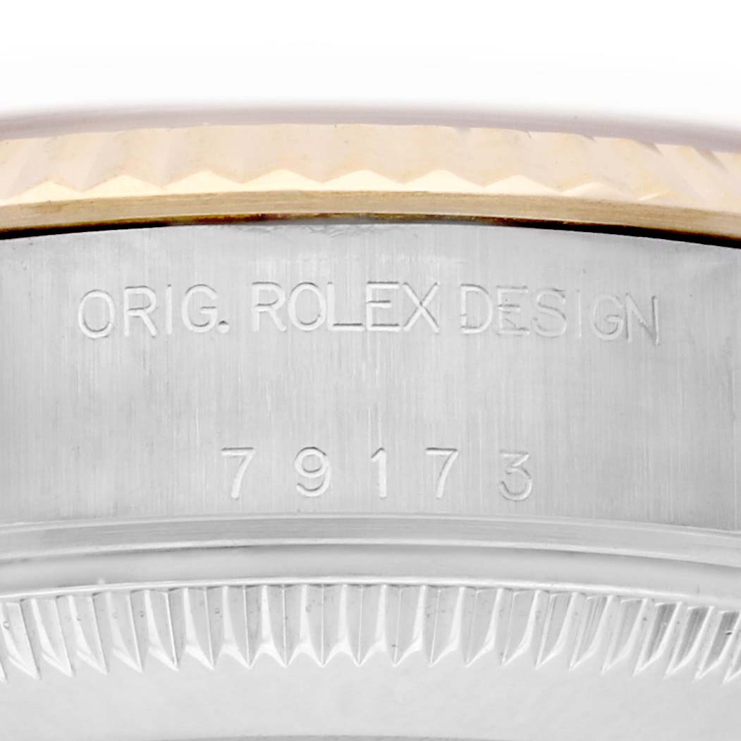 The image shows the case side of a Rolex Datejust 79173 Women's Steel and Gold (two tone) Champagne Dial 79173 Women's Steel and Gold (two tone) Champagne Dial, featuring the serial number and the "Orig. Rolex Design" engraving.