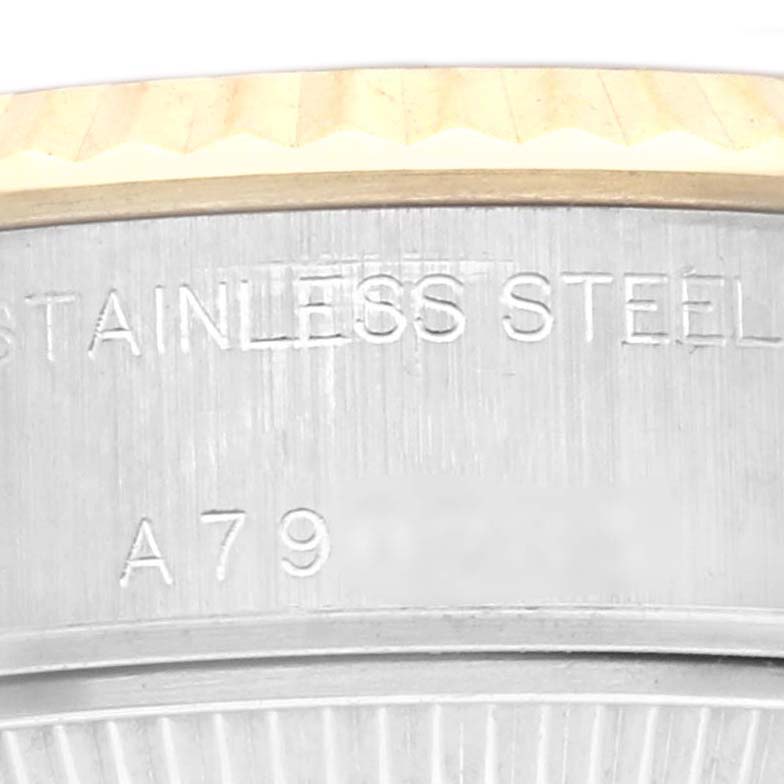 The image shows a close-up of the side of a Rolex Datejust 79173 Women's Steel and Gold (two tone) Silver Dial 79173 Women's Steel and Gold (two tone) Silver Dial, highlighting the stainless steel bezel and engraving.