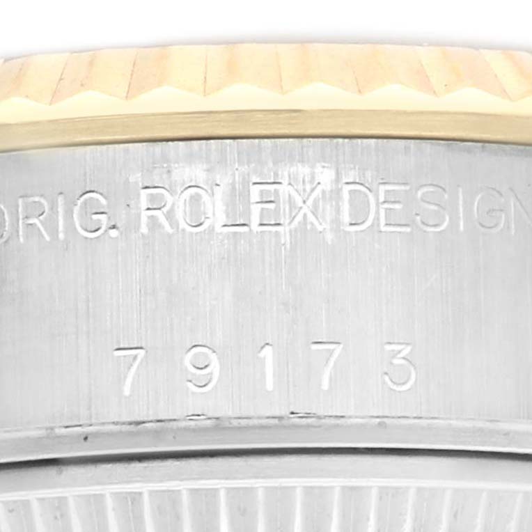 The image shows a close-up of the Rolex Datejust 79173 Women's Steel and Gold (two tone) Silver Dial 79173 Women's Steel and Gold (two tone) Silver Dial's side, highlighting the model number and some of the bezel.