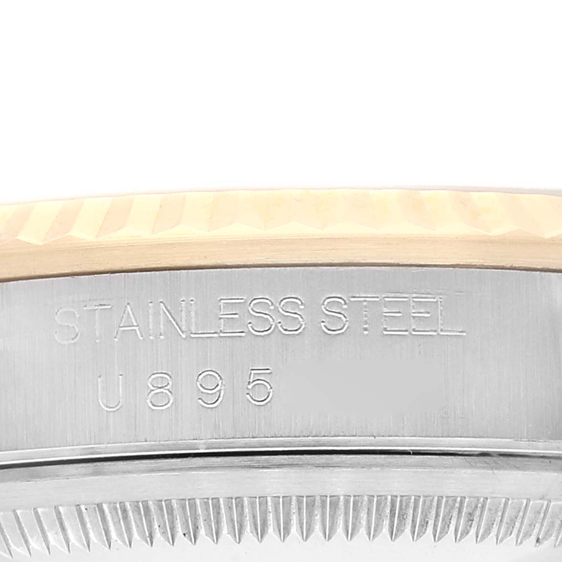 This image shows a partial side view of a Rolex Datejust 16233 Men's Steel and Gold (two tone) Silver Dial 16233 Men's Steel and Gold (two tone) Silver Dial watch case, focusing on the stainless steel engraving, bezel, and reference number.