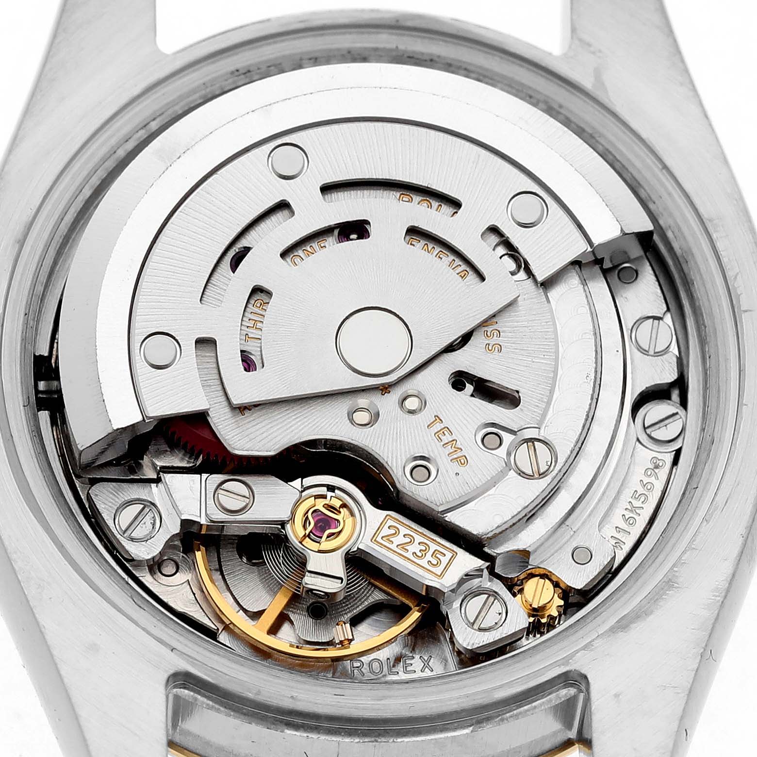 The image shows the movement of a Rolex Datejust 179173 Women's Stainless Steel Silver Dial watch from the back, highlighting its intricate mechanical parts.