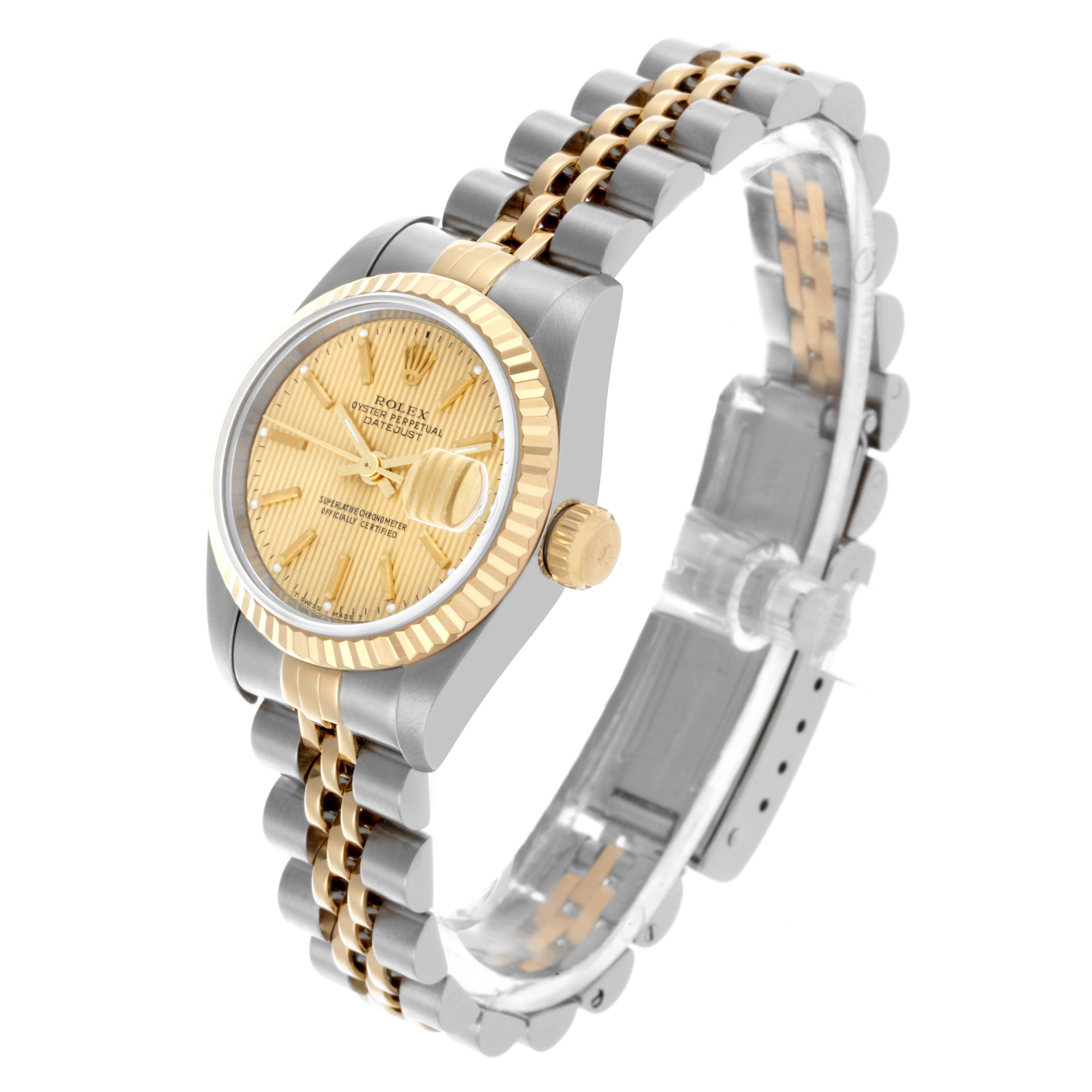 The Rolex Datejust 69173 Women's Steel and Gold (two tone) Champagne Dial 69173 Women's Steel and Gold (two tone) Champagne Dial watch is shown at a three-quarter angle, highlighting the face, fluted bezel, winding crown, and bicolored bracelet.