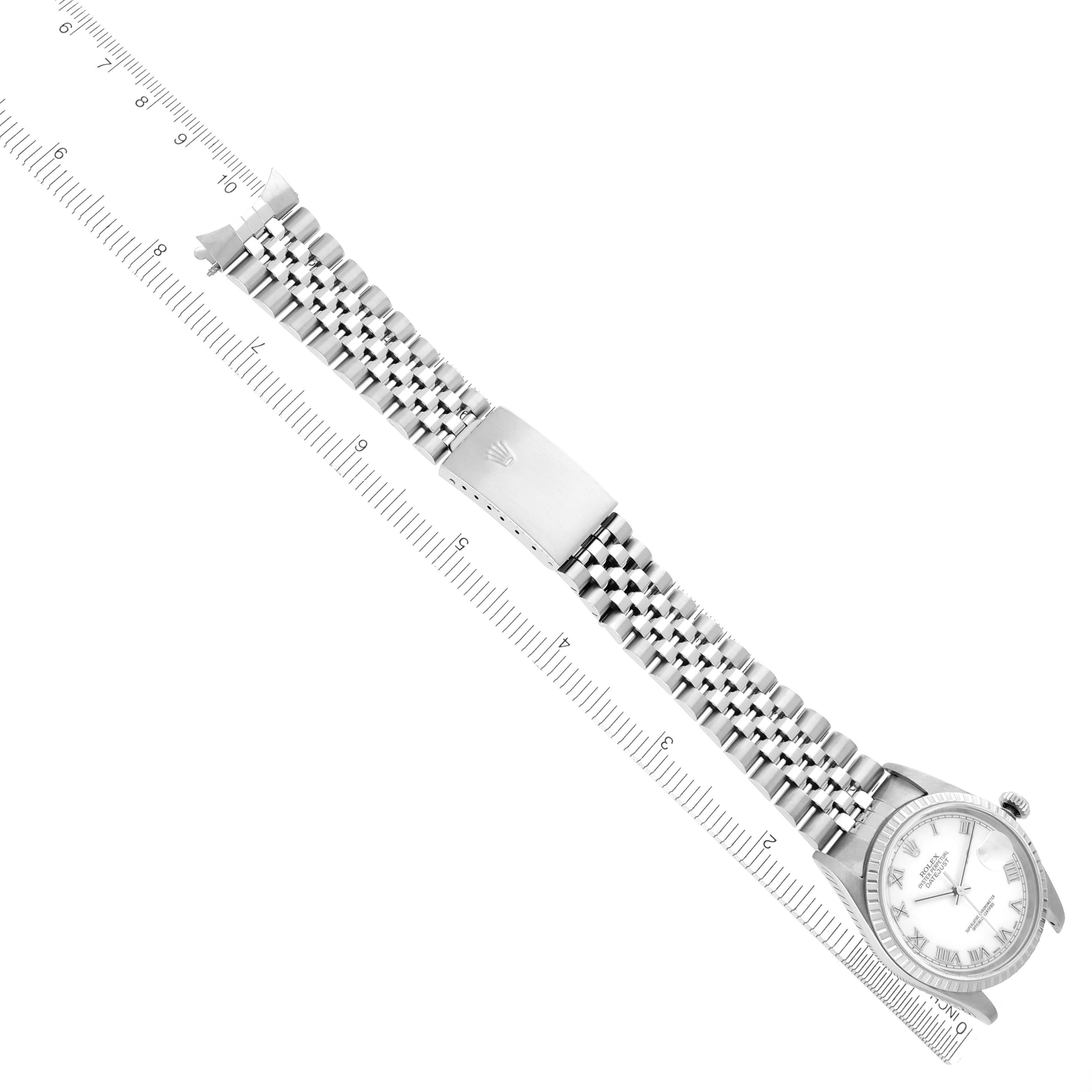 The image shows a Rolex Datejust 16220 Men
s Stainless Steel White Dial 16220 Men
s Stainless Steel White Dial watch from an angled top-down view, displaying the entire bracelet and clasp alongside a ruler.