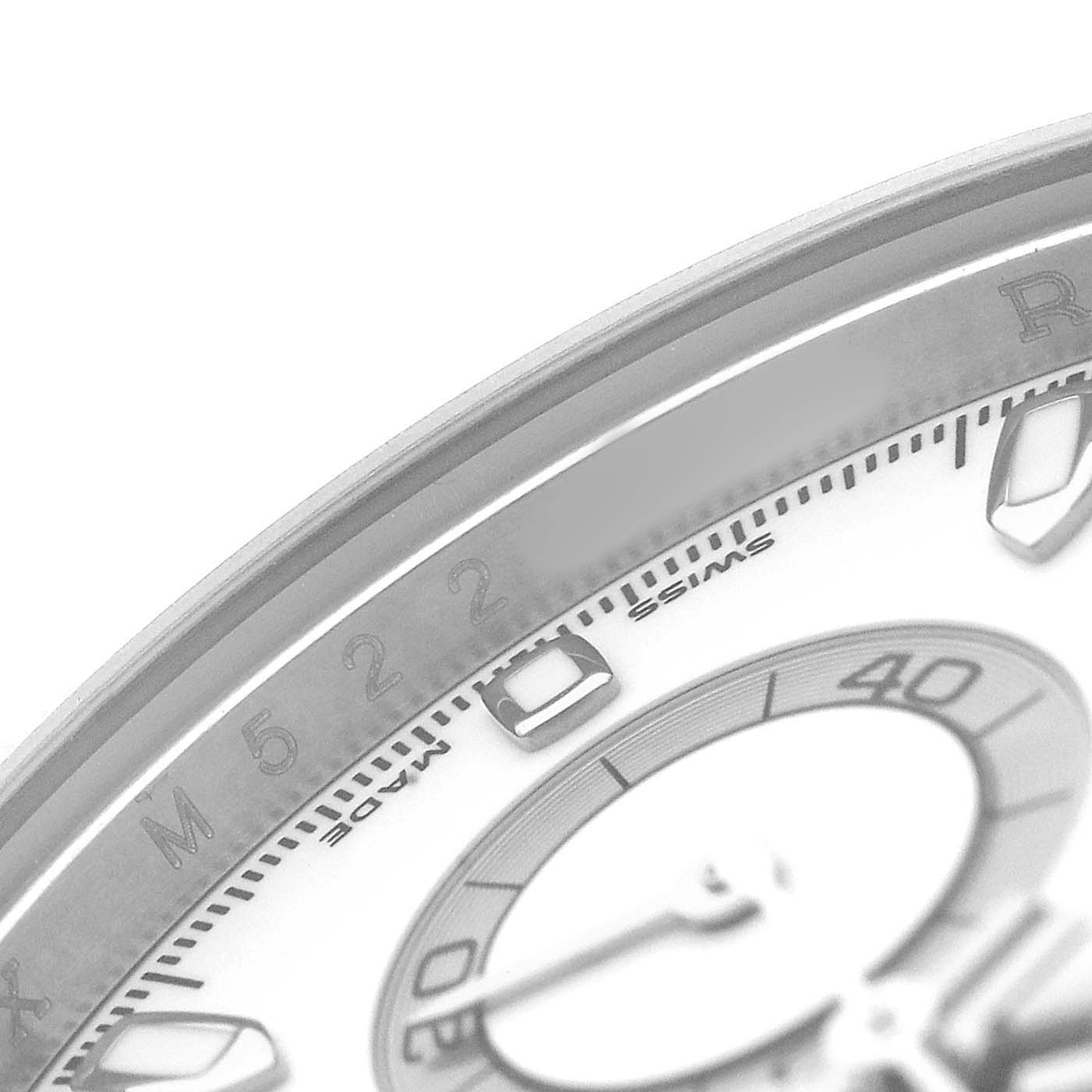 The image shows a close-up of the dial's edge and sub-dial of a Rolex Daytona 116520 Men's Stainless Steel White Dial, highlighting part of the bezel and hour markers.