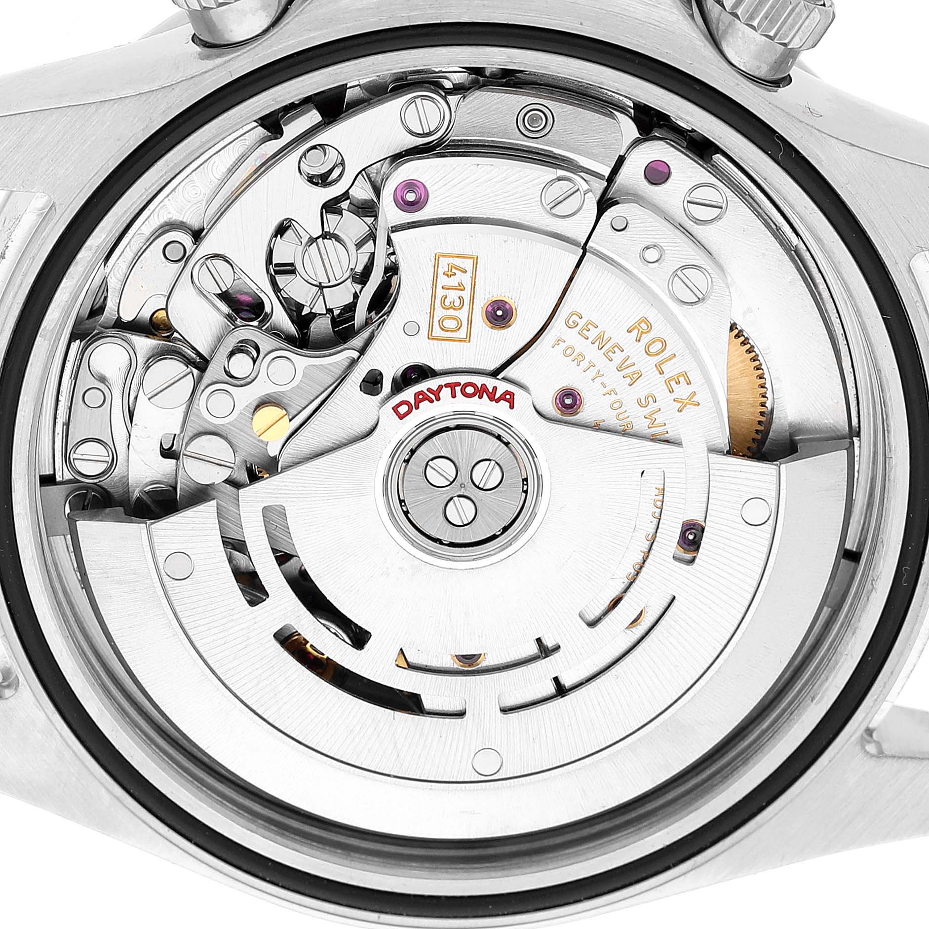 The image shows the movement mechanism of a Rolex Daytona 116520 Men's Stainless Steel White Dial watch from a rear angle, highlighting gears and the oscillating weight.