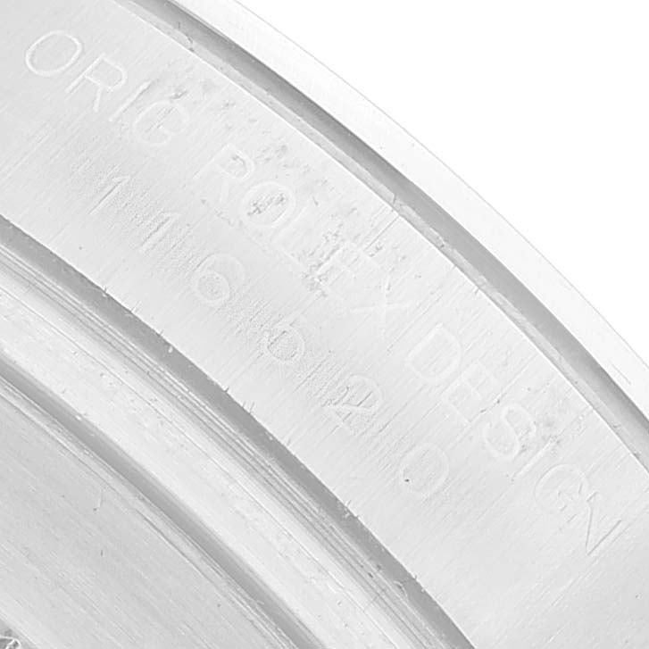 The image shows a close-up of the engraving on the inner rim of a Rolex Daytona 116520 Men's Stainless Steel White Dial watch case.