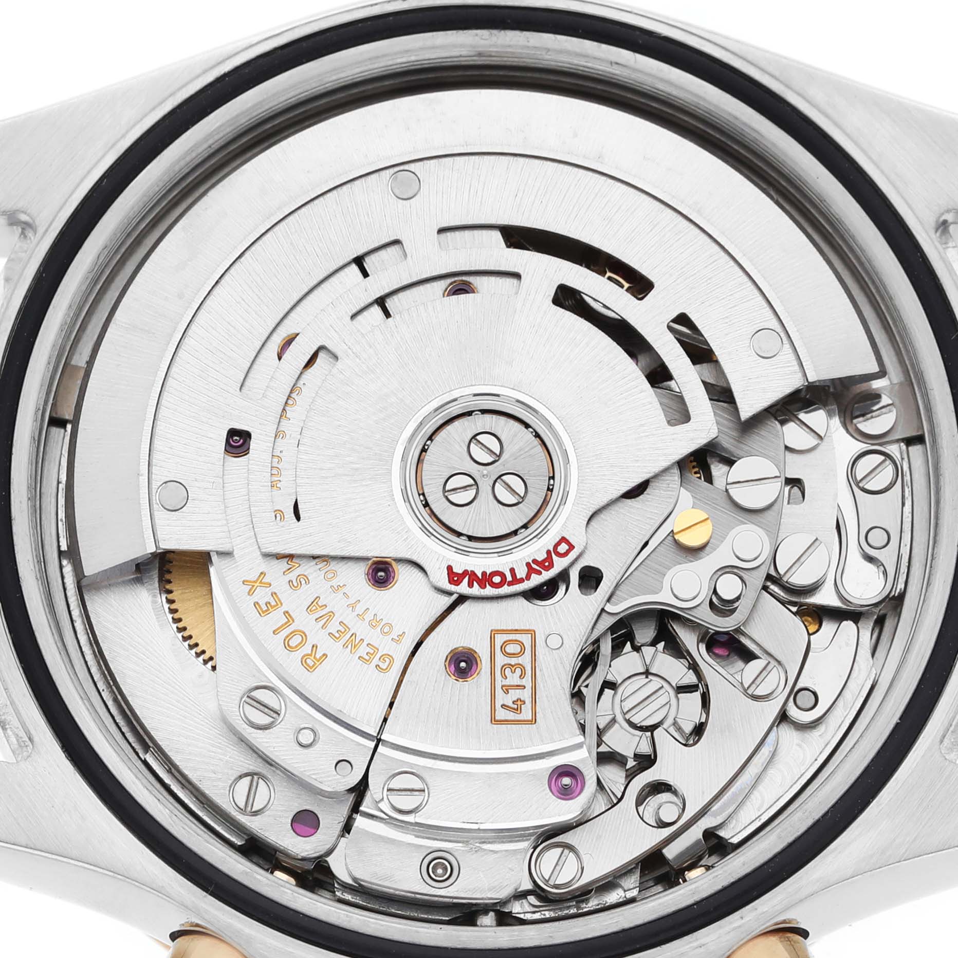 The image shows a close-up view of the Rolex Daytona 116523 Men's Steel and Gold (two tone) White Dial's movement, revealing intricate mechanical parts from the back.