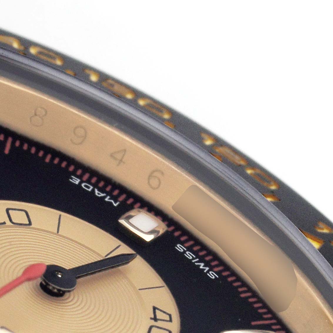 The image shows a close-up of the dial and bezel of a Rolex Daytona 116518 Men's Yellow Gold Black Dial watch, highlighting the numbers and part of the sub-dial.