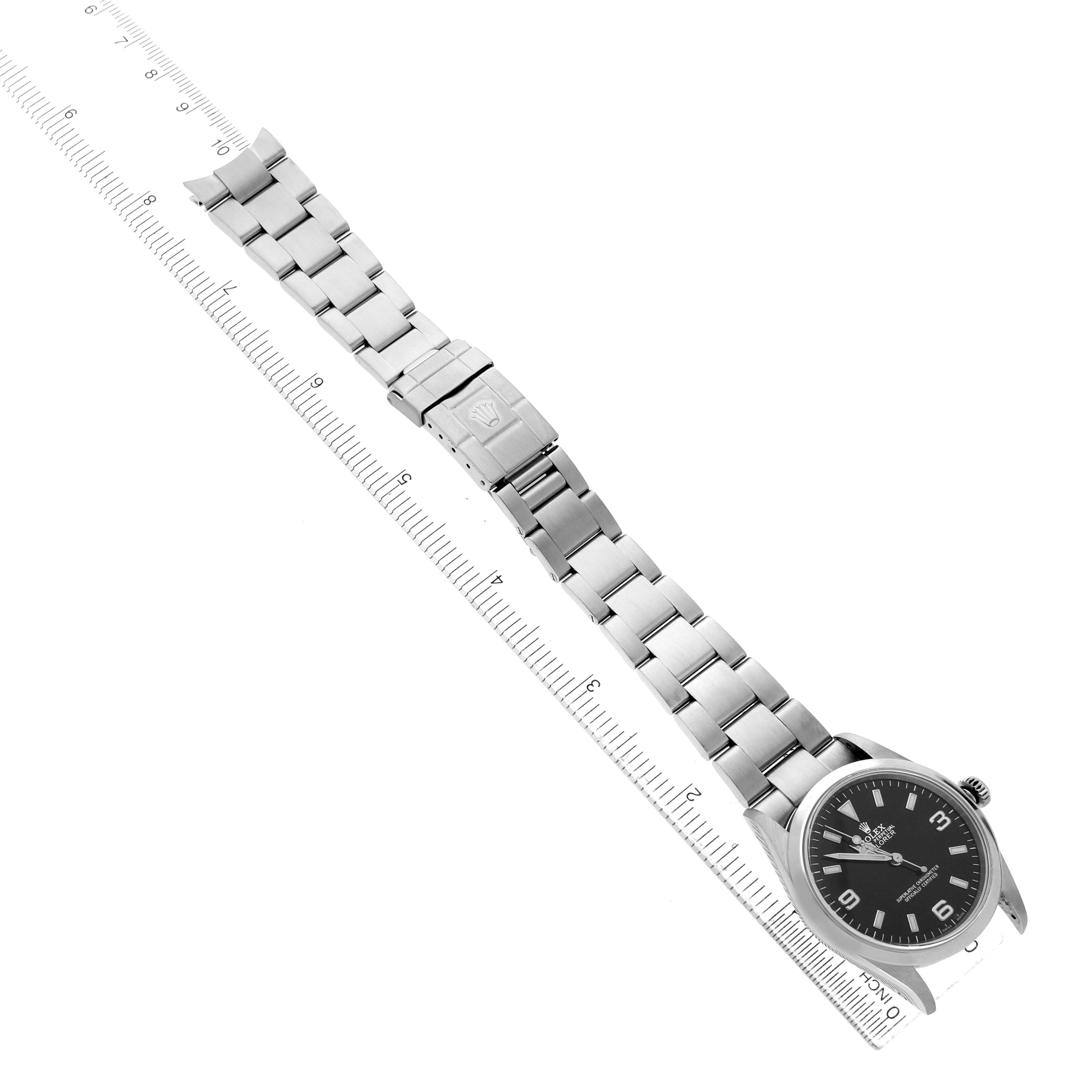 The Rolex Explorer 114270 Men's Stainless Steel Black Dial watch is shown from a top-down angle, displaying the full bracelet, clasp, and face.