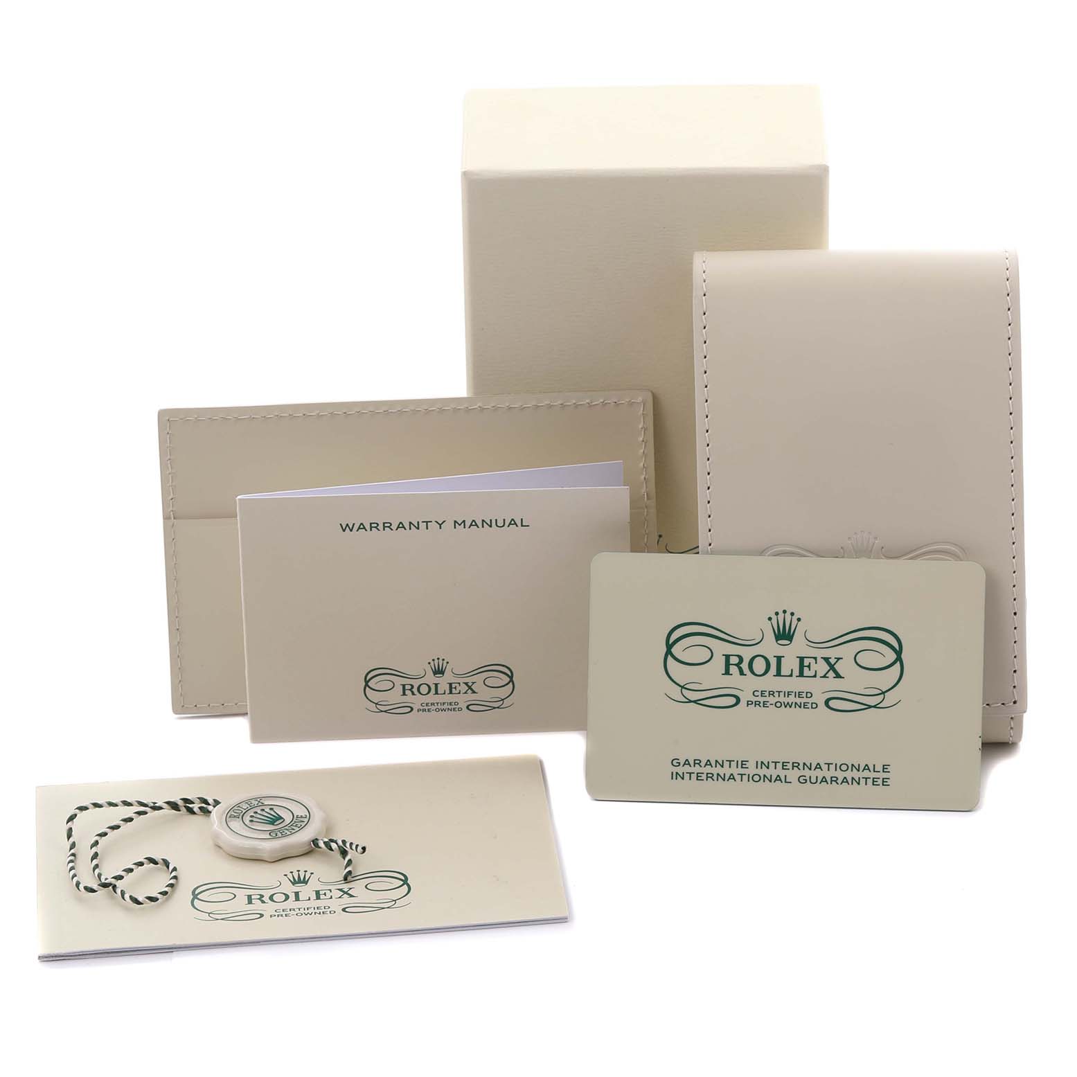 The image shows accessories for a Rolex Explorer 214270 Men's Stainless Steel Black Dial 214270 Men's Stainless Steel Black Dial, including a warranty manual, a certification card, a box, and a tag.