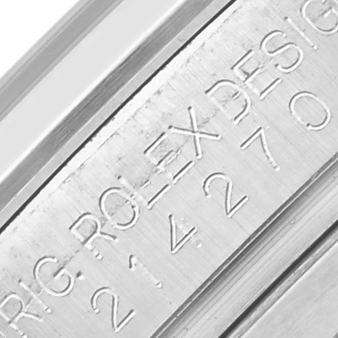 The image shows a close-up of the engraving on the inner bezel of a Rolex Explorer 214270 Men's Stainless Steel Black Dial 214270 Men's Stainless Steel Black Dial watch.