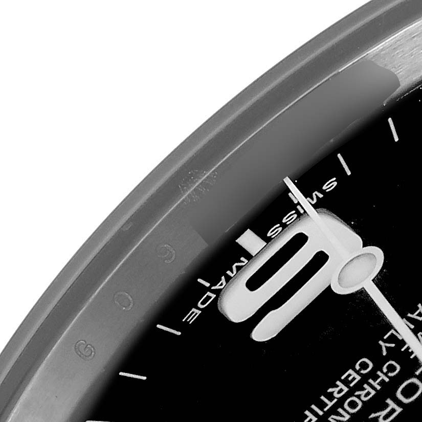 The image shows a close-up of the dial and bezel edge of a Rolex Explorer 214270 Men's Stainless Steel Black Dial 214270 Men's Stainless Steel Black Dial watch, focusing on the '9', minute markers, and "Swiss Made" text.
