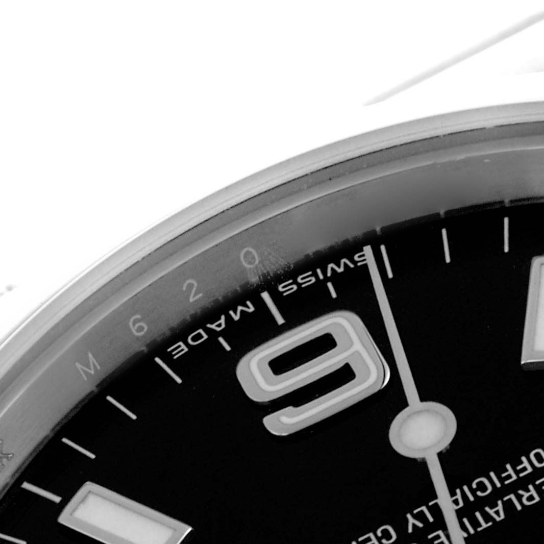 The image shows a close-up angle of the Rolex Explorer 114270 Men's Stainless Steel Black Dial 114270 Men's Stainless Steel Black Dial's dial, highlighting the "9," minute markers, and "Swiss Made" text.