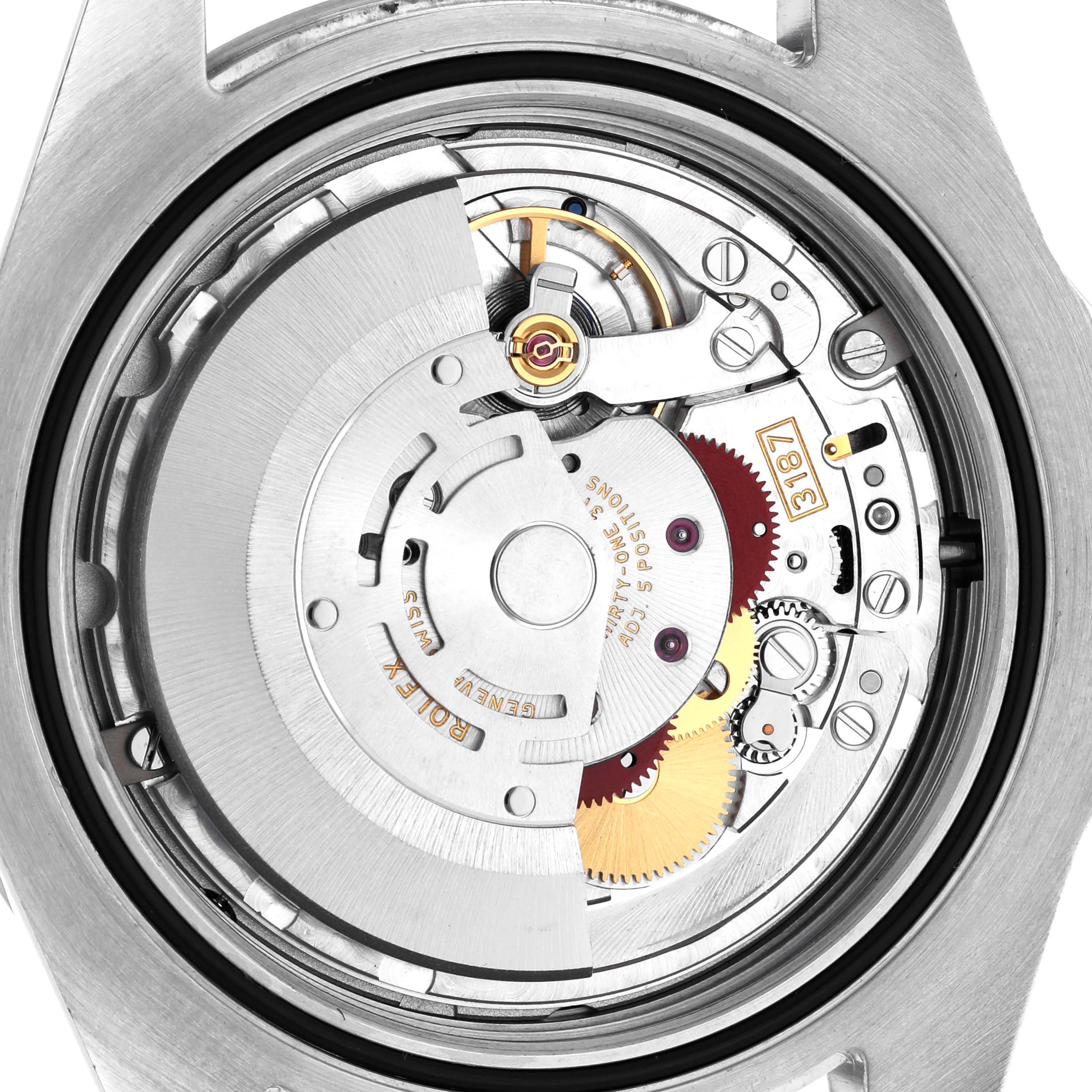 The image shows the movement of a Rolex Explorer 216570 Men's Stainless Steel Black Dial 216570 Men's Stainless Steel Black Dial watch from the back, highlighting gears and the rotor.