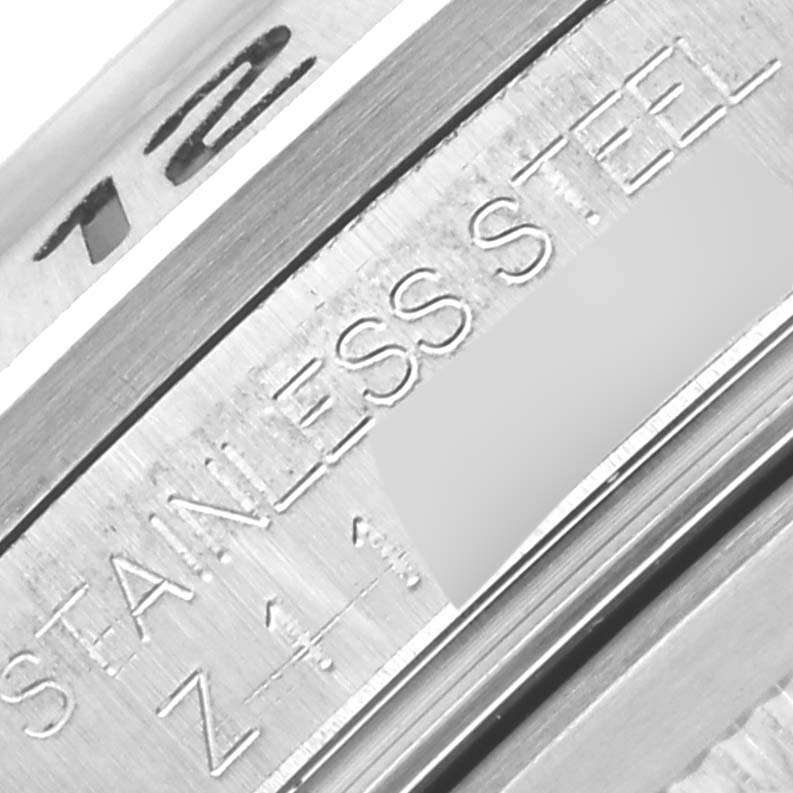 The image shows a close-up of the inner bezel of the Rolex Explorer 16570 Men's Stainless Steel White Dial 16570 Men's Stainless Steel White Dial, highlighting "STAINLESS STEEL" and part of the reference number.