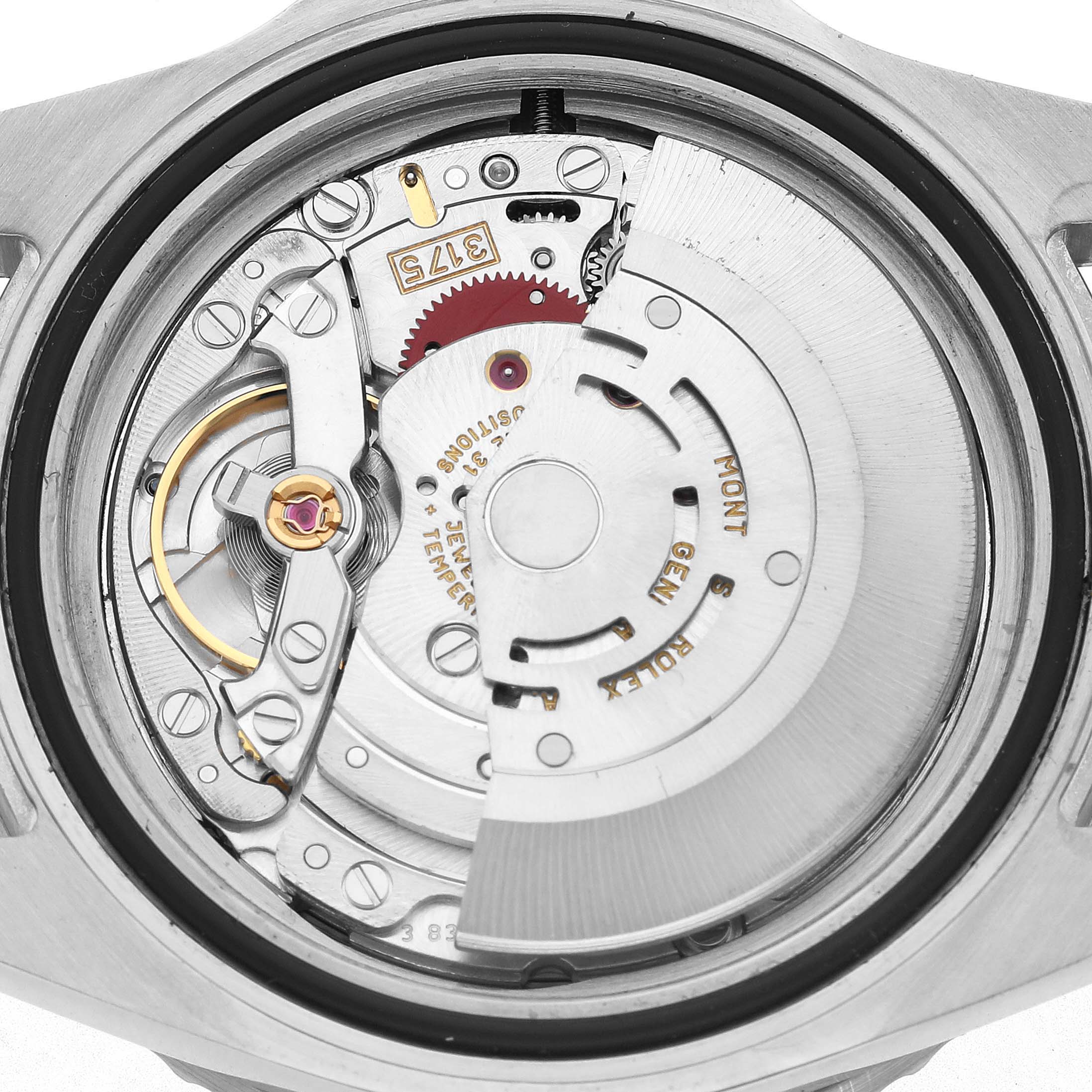 The image shows a close-up view of the movement of a Rolex GMT-Master 16700 Men's Stainless Steel Black Dial watch, highlighting the rotor and gears.