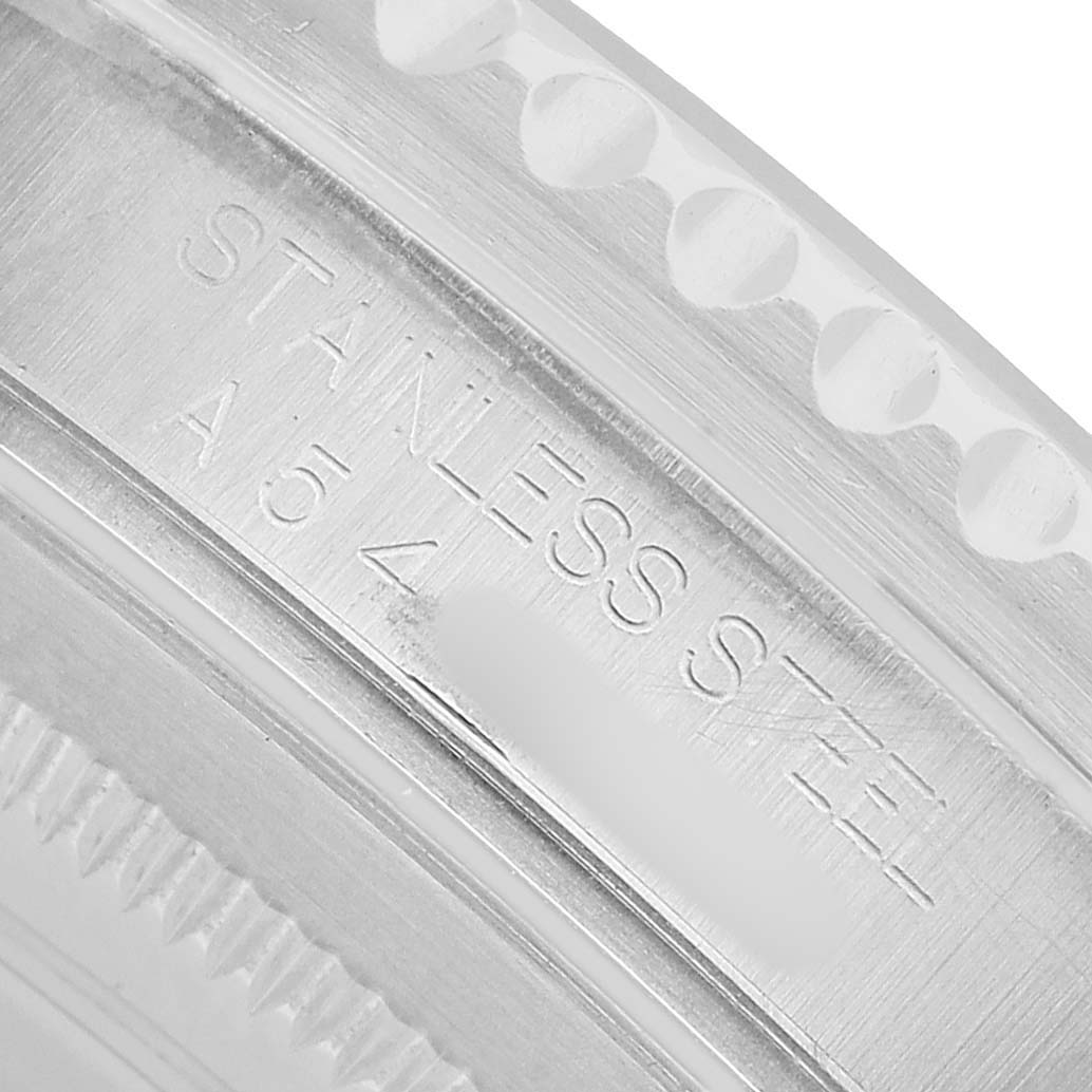 The image shows a close-up of the Rolex GMT-Master 16700 Men's Stainless Steel Black Dial model's stainless steel case side, highlighting engraving details.