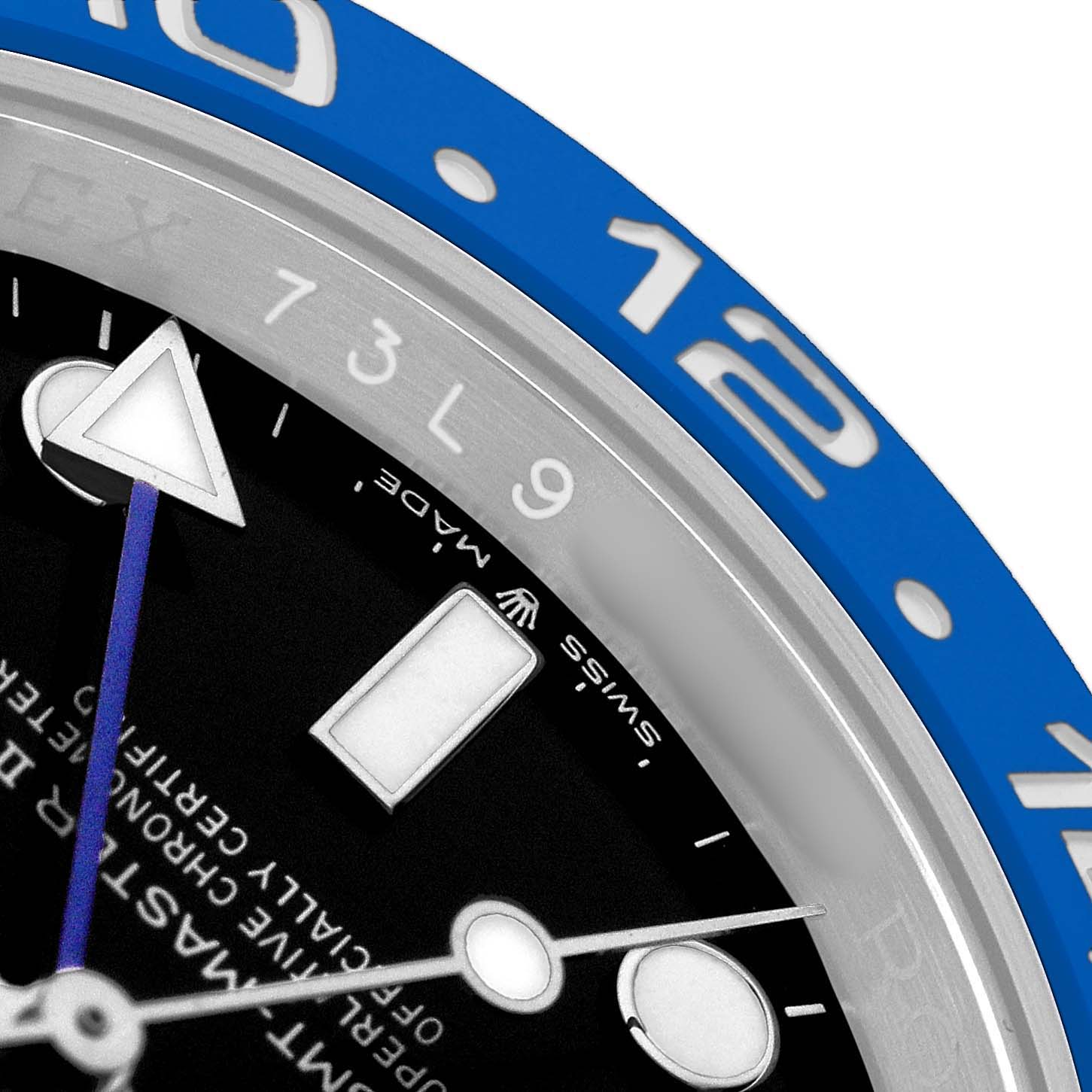 The image shows a close-up of the GMT-Master model by Rolex, focusing on the bezel, dial, and hour markers.