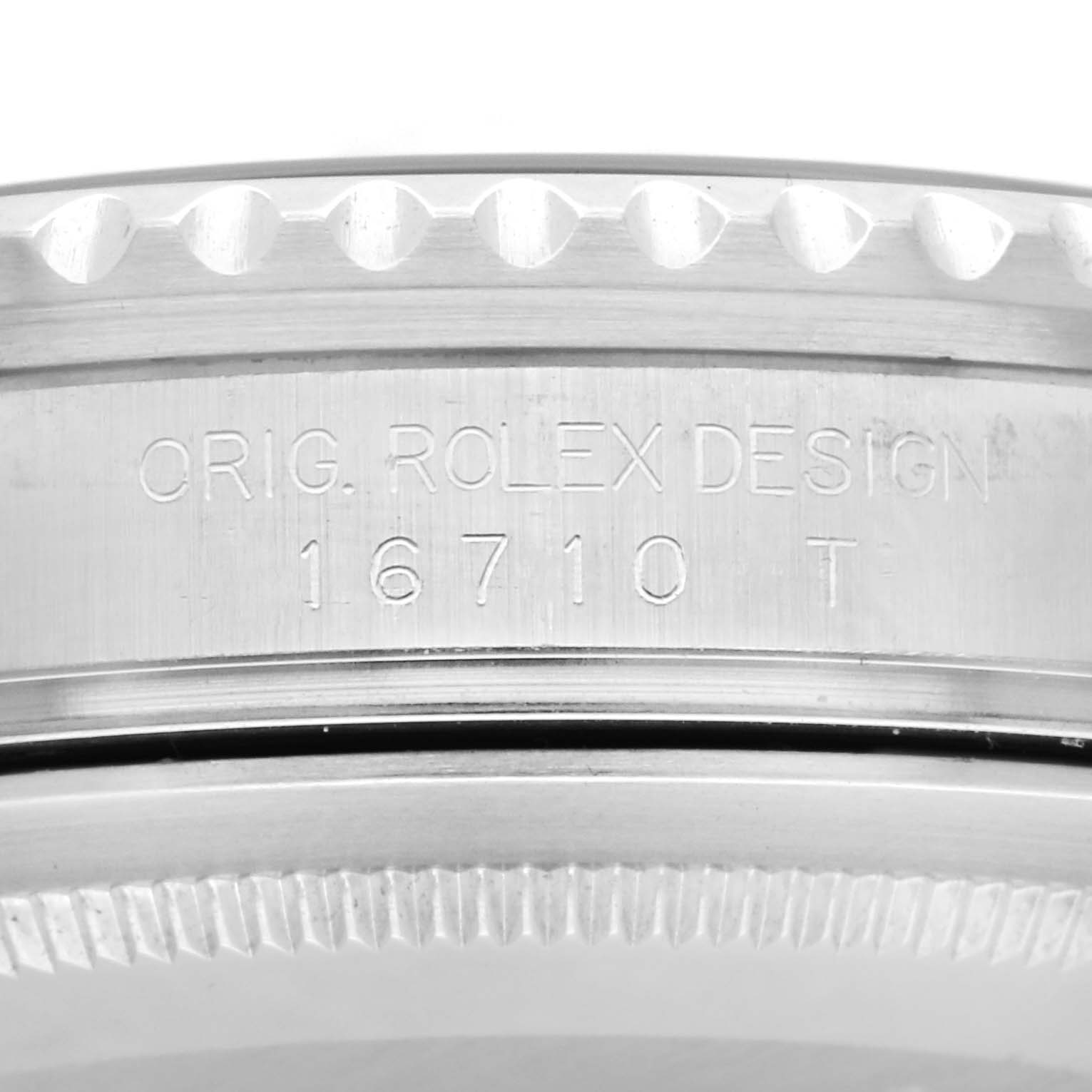 The image shows a close-up of the side of a Rolex GMT-Master 16710T Men
s Stainless Steel Black Dial 16710T Men
s Stainless Steel Black Dial watch, highlighting the engraved model number "16710 T" and bezel edge.
