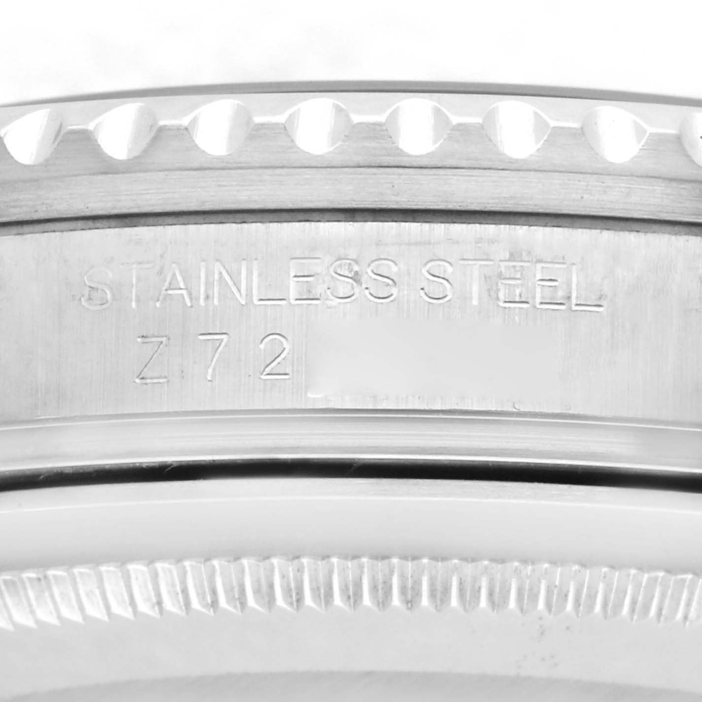 The image shows a close-up of the edge and case back of a Rolex GMT-Master 16710T Men
s Stainless Steel Black Dial 16710T Men
s Stainless Steel Black Dial, highlighting the "STAINLESS STEEL" engraving.