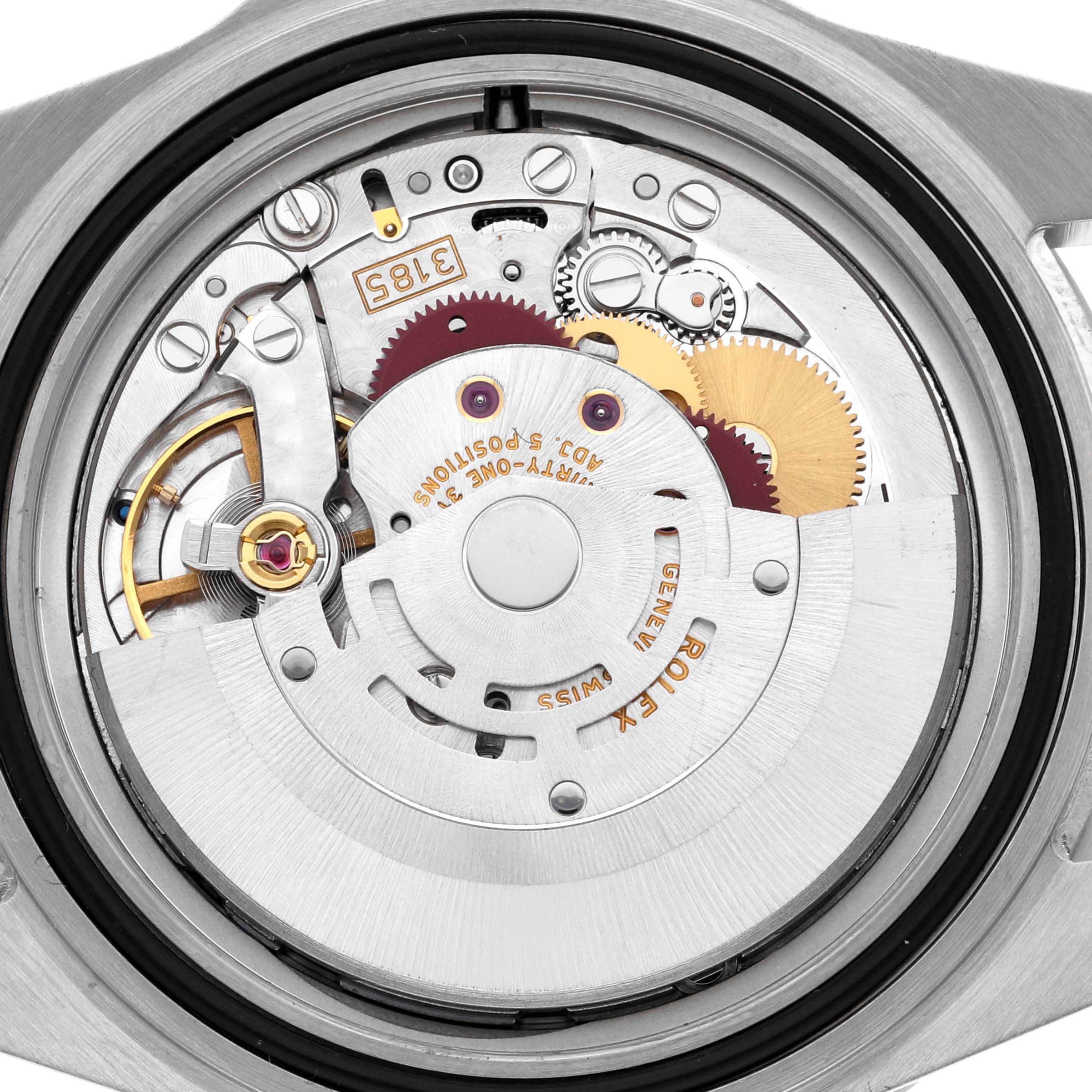 The image shows the movement of a Rolex GMT-Master 16710T Men
s Stainless Steel Black Dial 16710T Men
s Stainless Steel Black Dial watch from a top-down angle, highlighting gears and mechanical components.