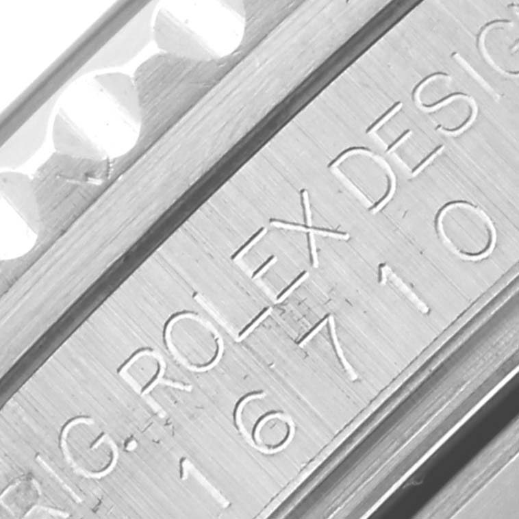 The image shows a close-up of the engraved side of the GMT-Master Rolex watch, highlighting the model number.