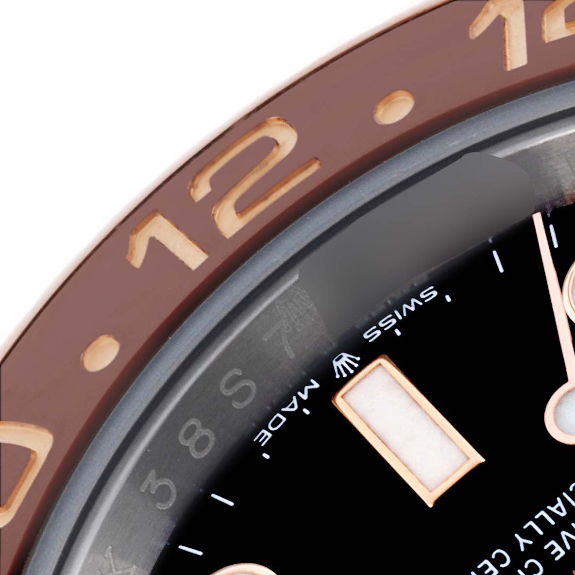 This close-up image of a Rolex GMT-Master 126711 Men's Steel and Gold (two tone) Black Dial 126711 Men's Steel and Gold (two tone) Black Dial watch highlights the bezel and part of the dial with hour markers and hands.