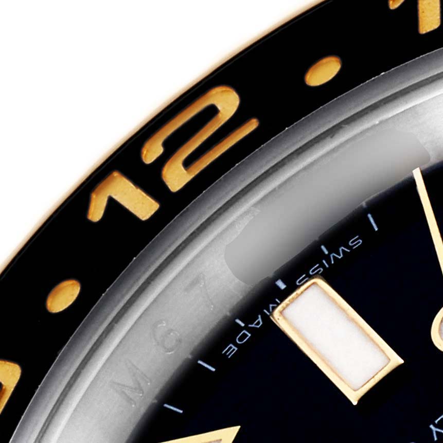 The image shows a close-up of the Rolex GMT-Master 116713LN Men's Steel and Gold (two tone) Black Dial 116713LN Men's Steel and Gold (two tone) Black Dial watch, highlighting the bezel and part of the dial with markers.