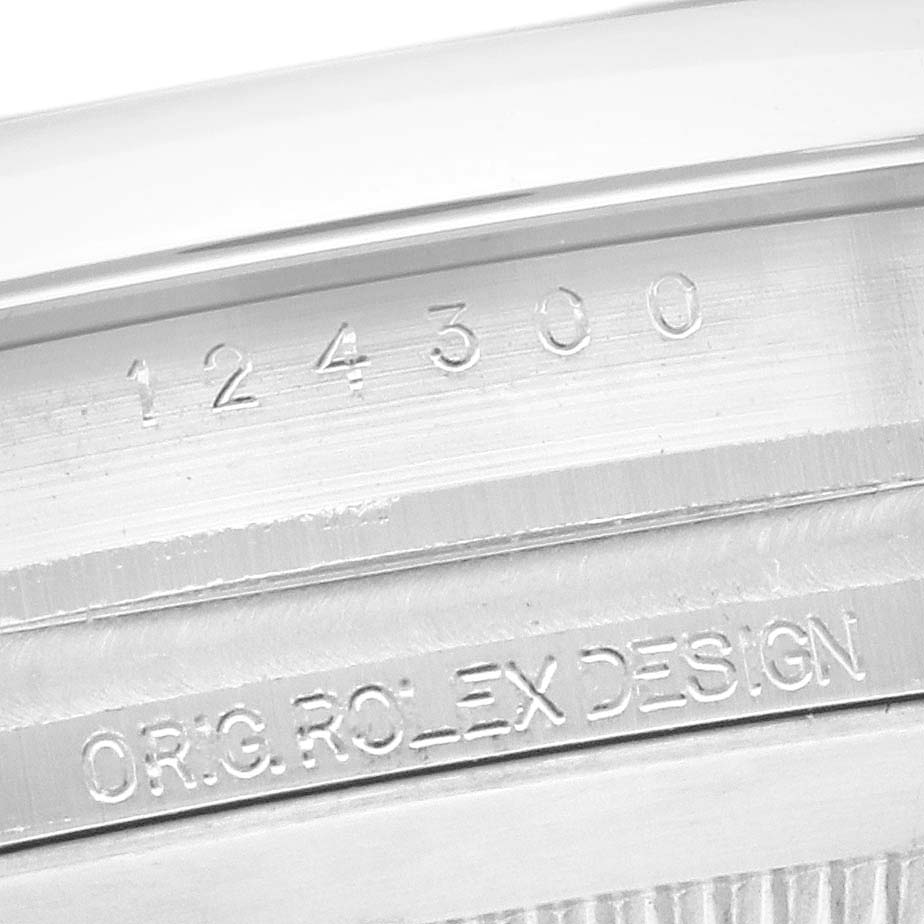 The image shows a close-up of the case side, featuring engravings on a Rolex Oyster Perpetual 124300 Men
s Stainless Steel Black Dial 124300 Men
s Stainless Steel Black Dial model.