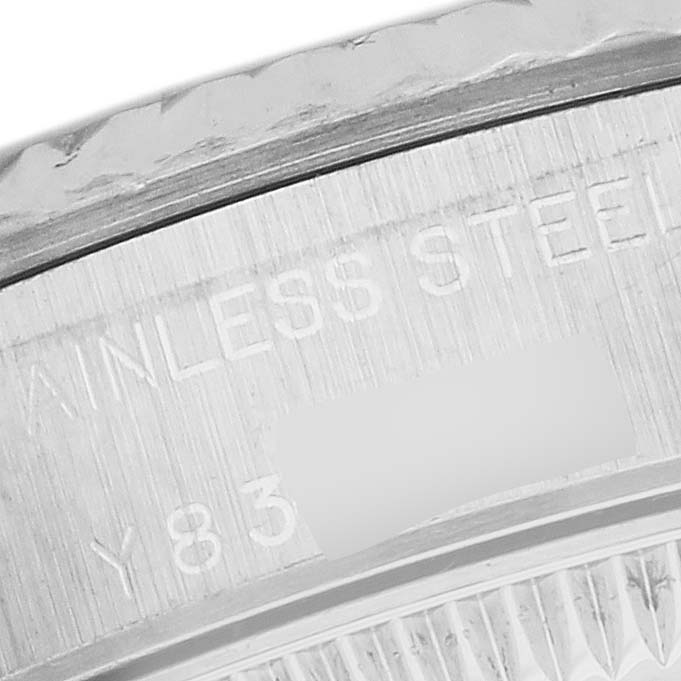 This close-up image shows the side of a Rolex Oyster Perpetual 76094 Women's Stainless Steel Black Dial 76094 Women's Stainless Steel Black Dial watch, focusing on the stainless steel engraving.