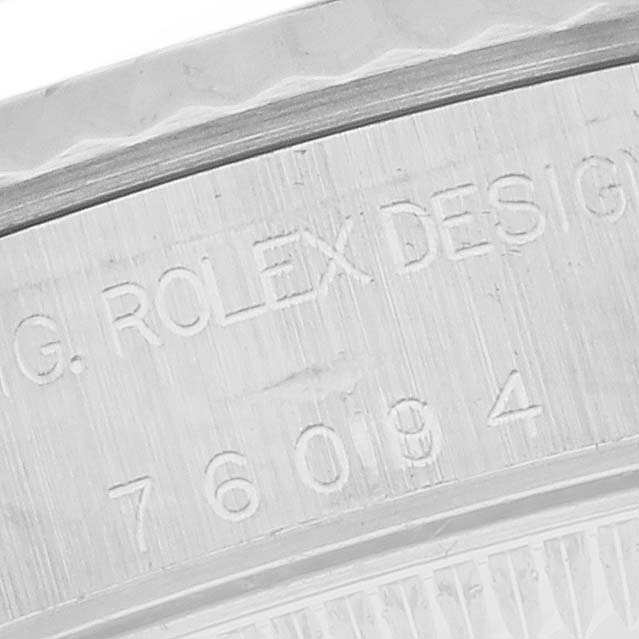 The image shows a close-up of the case engraving on a Rolex Oyster Perpetual 76094 Women's Stainless Steel Black Dial 76094 Women's Stainless Steel Black Dial watch, highlighting the model number.