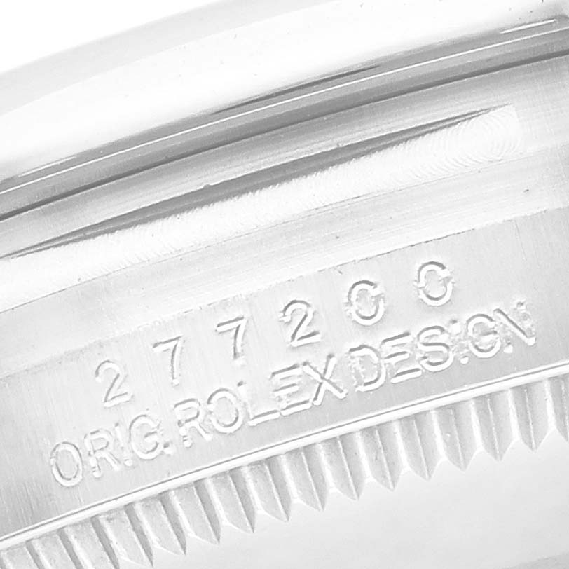 The image shows a close-up of the watch case's edge with engravings for a Rolex Mid-Size 277200 Women's Stainless Steel Red Dial 277200 Women's Stainless Steel Red Dial model.