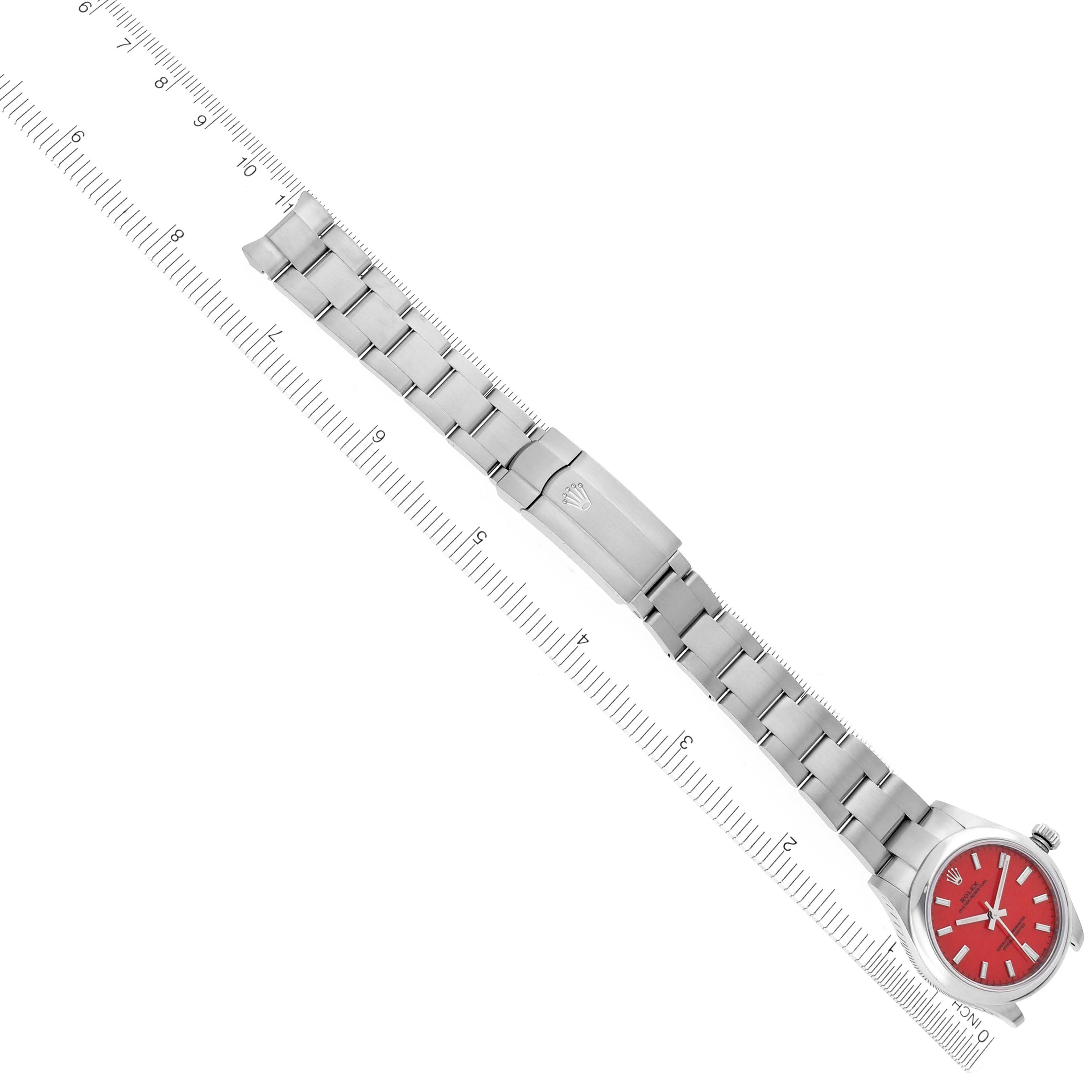 The Rolex Mid-Size 277200 Women's Stainless Steel Red Dial 277200 Women's Stainless Steel Red Dial watch is shown from a top-down angle, displaying the full bracelet and red dial.