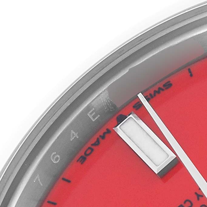 The image shows a close-up of the dial and the edge of the bezel of a Rolex Mid-Size 277200 Women's Stainless Steel Red Dial 277200 Women's Stainless Steel Red Dial watch.