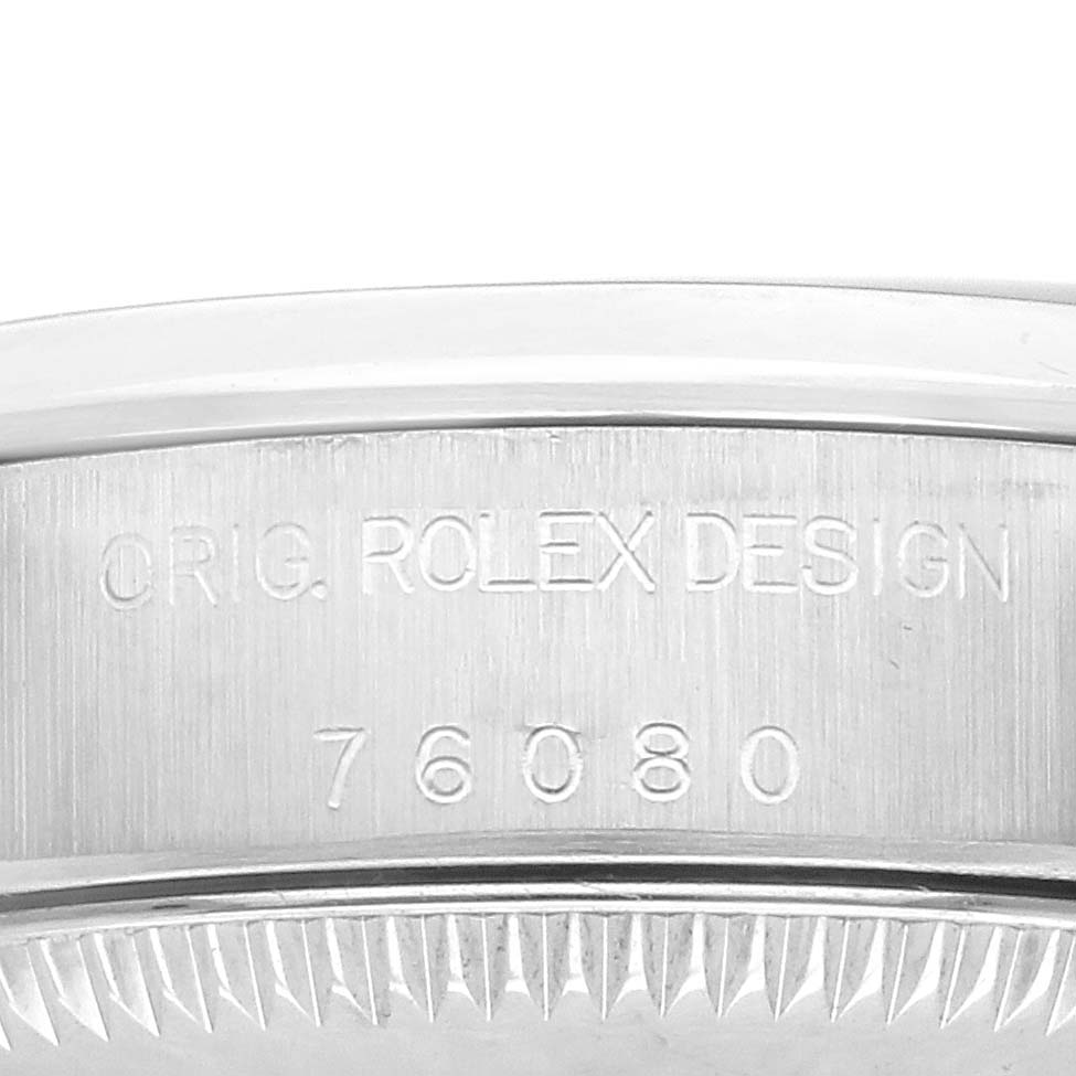 The image shows the side view of a Rolex Oyster Perpetual 76080 Women's Stainless Steel Pink Dial 76080 Women's Stainless Steel Pink Dial watch case, highlighting the engraved design and model number "76080".
