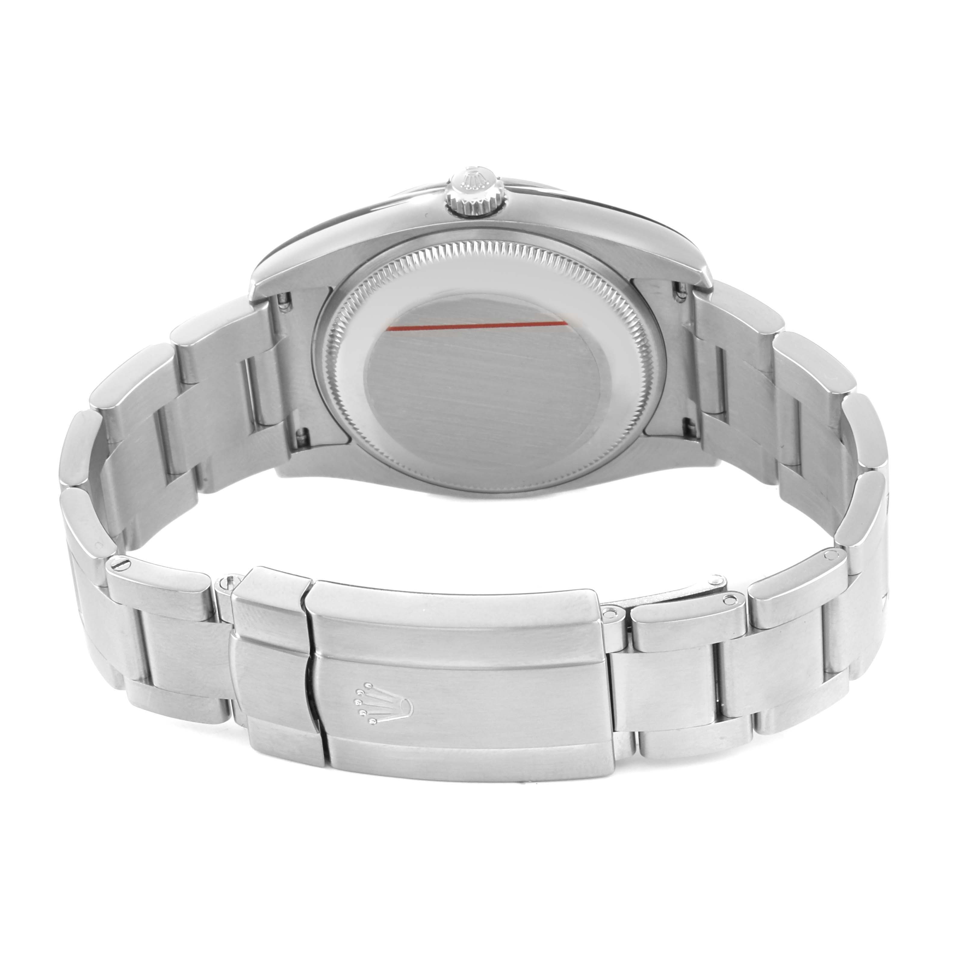 The image shows the back view of a Rolex Oyster Perpetual 114200 Men's Stainless Steel Silver Dial watch, highlighting the case back, bracelet, and clasp.