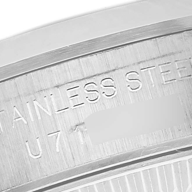 The image shows a close-up of the engraved caseback of a Rolex Oyster Perpetual 67180 Women's Stainless Steel Pink Dial 67180 Women's Stainless Steel Pink Dial watch, emphasizing the "STAINLESS STEEL" text.