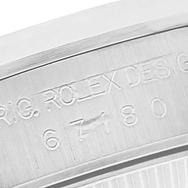 The image shows a close-up of the brushed metal side, featuring engraving on a Rolex Oyster Perpetual 67180 Women's Stainless Steel Pink Dial 67180 Women's Stainless Steel Pink Dial watch.