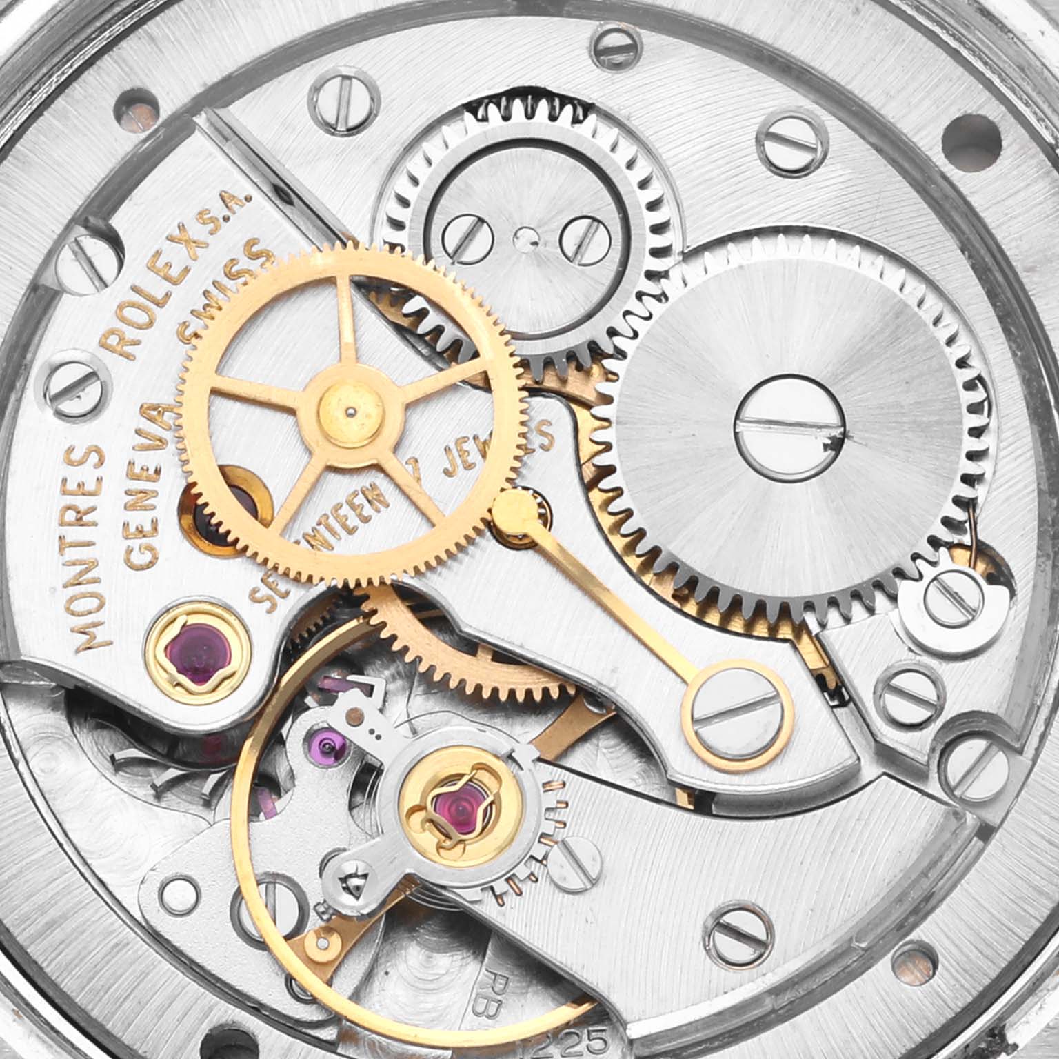 The image shows a close-up view of the Rolex Date 6694 Men's Stainless Steel Silver Dial 6694 Men's Stainless Steel Silver Dial watch movement, highlighting gears and jewels.