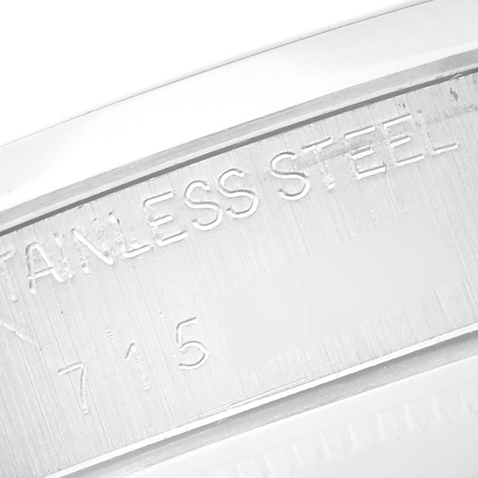 The image shows a close-up of the side engraving on a Rolex Date 6694 Men's Stainless Steel Silver Dial 6694 Men's Stainless Steel Silver Dial, highlighting the "STAINLESS STEEL" marking.