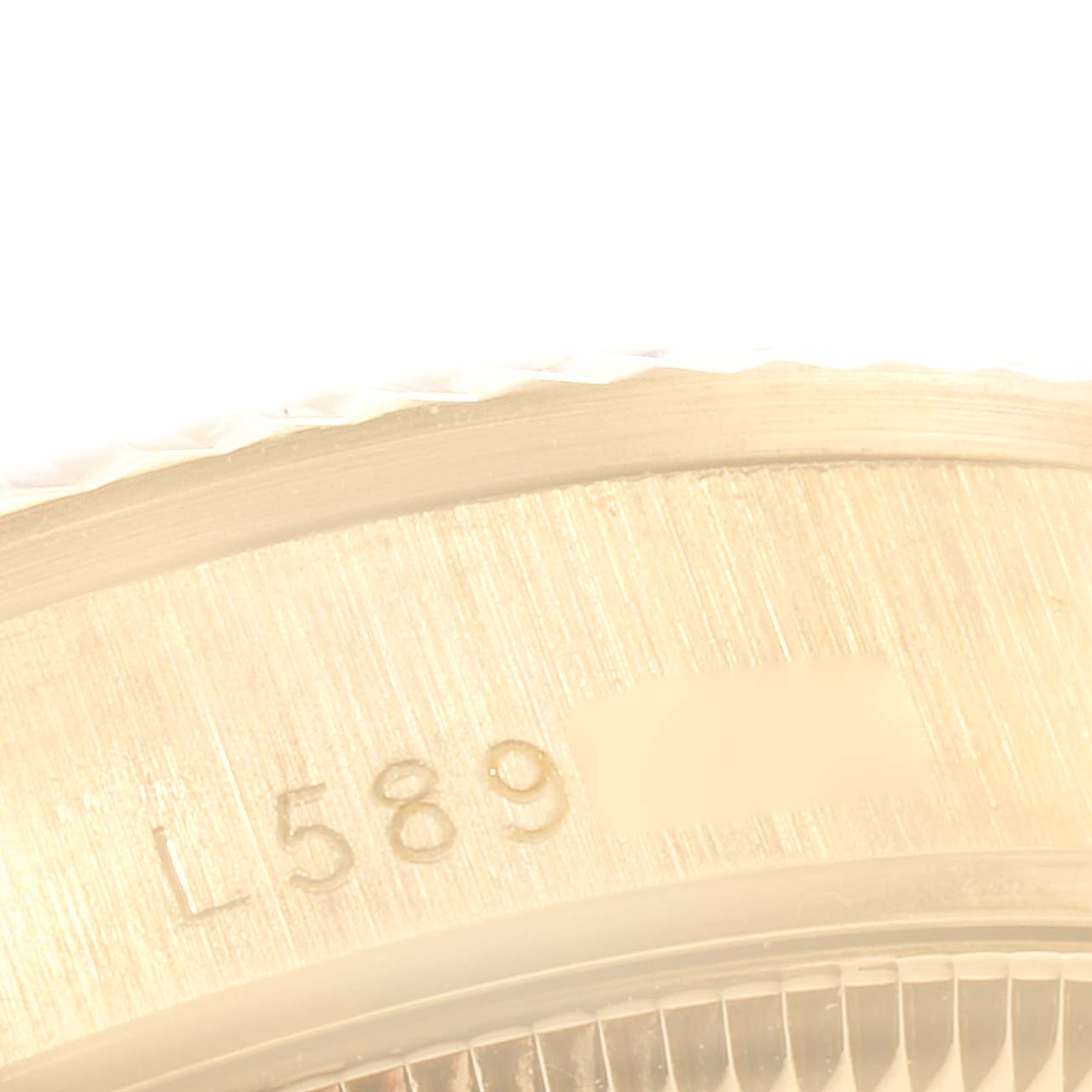 This image shows a close-up of the serial number engraving on the case back of the Rolex President 68278 Women
s Yellow Gold Champagne Dial 68278 Women
s Yellow Gold Champagne Dial model watch.