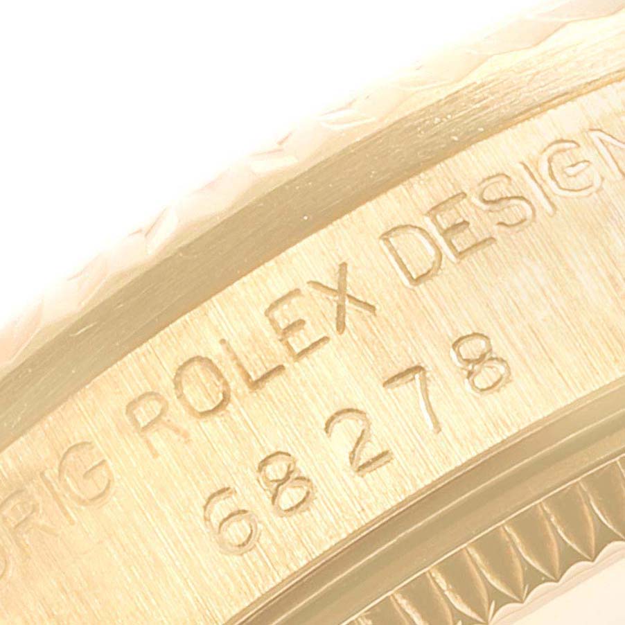 The image shows a close-up of the engravings on the bezel of a Rolex President 68278 Women
s Yellow Gold Champagne Dial 68278 Women
s Yellow Gold Champagne Dial model watch.