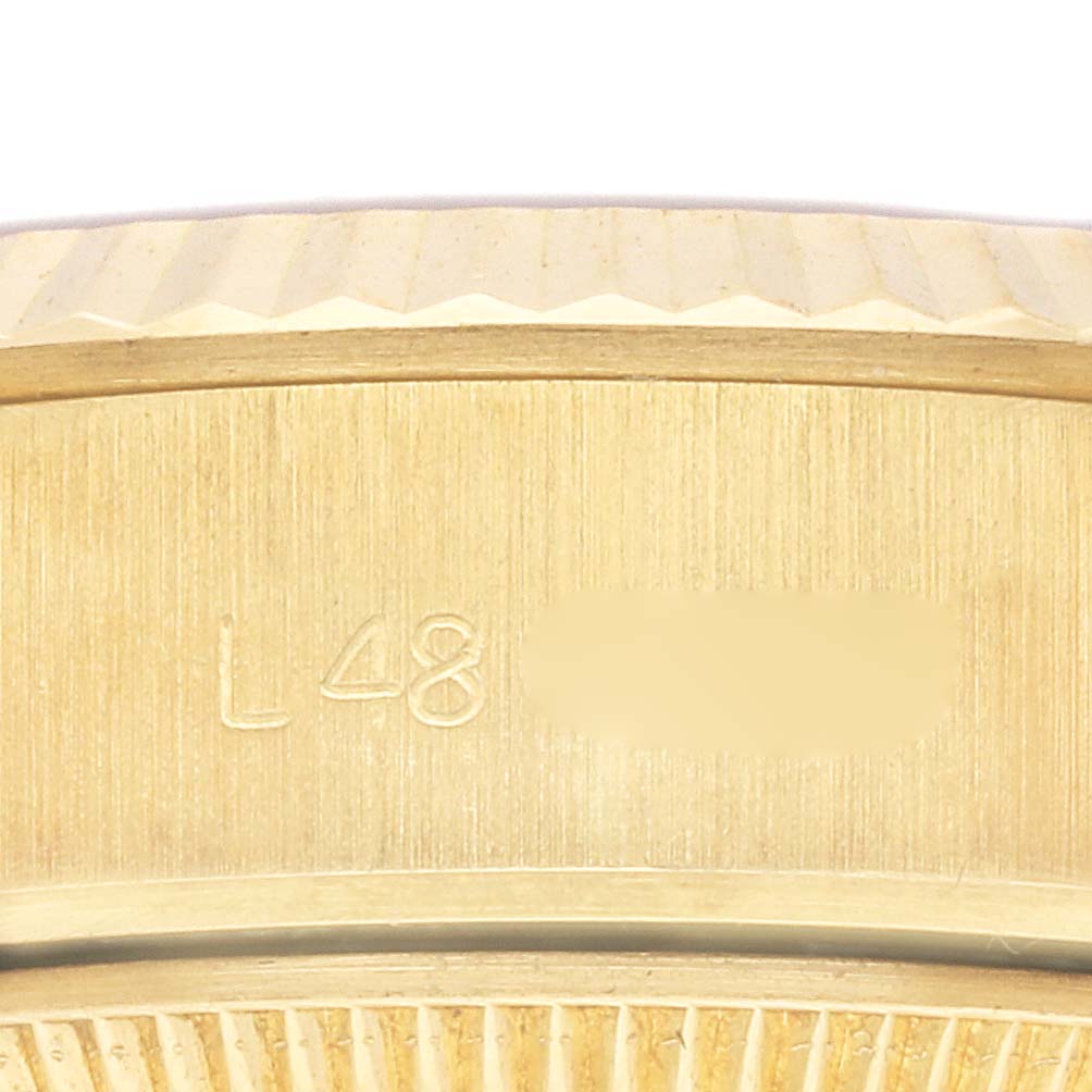 The image shows a close-up of the side of a Rolex President 69178 Women's Yellow Gold Champagne Dial 69178 Women's Yellow Gold Champagne Dial model, focusing on details of the bezel and case.