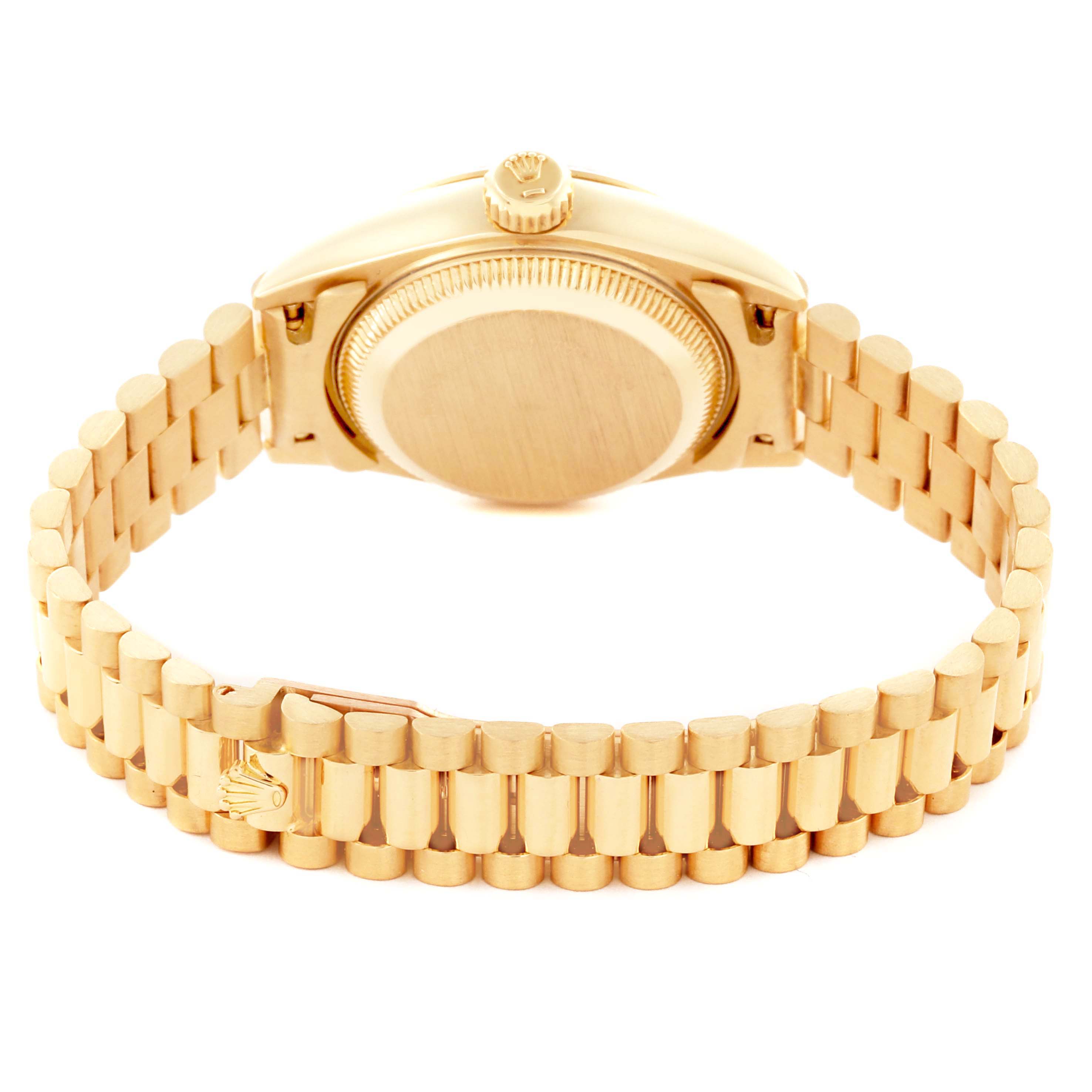 The image shows the backside of the Rolex President 69178 Women's Yellow Gold Champagne Dial 69178 Women's Yellow Gold Champagne Dial watch, including the clasp and the case back.