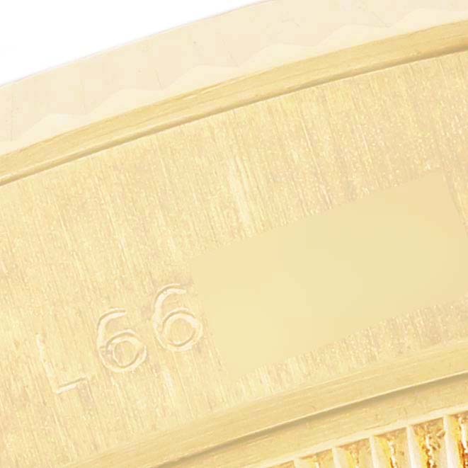 The image shows a close-up of the textured gold surface and engraving on the Rolex President 69178 Women's Yellow Gold Champagne Dial 69178 Women's Yellow Gold Champagne Dial model watch bezel.