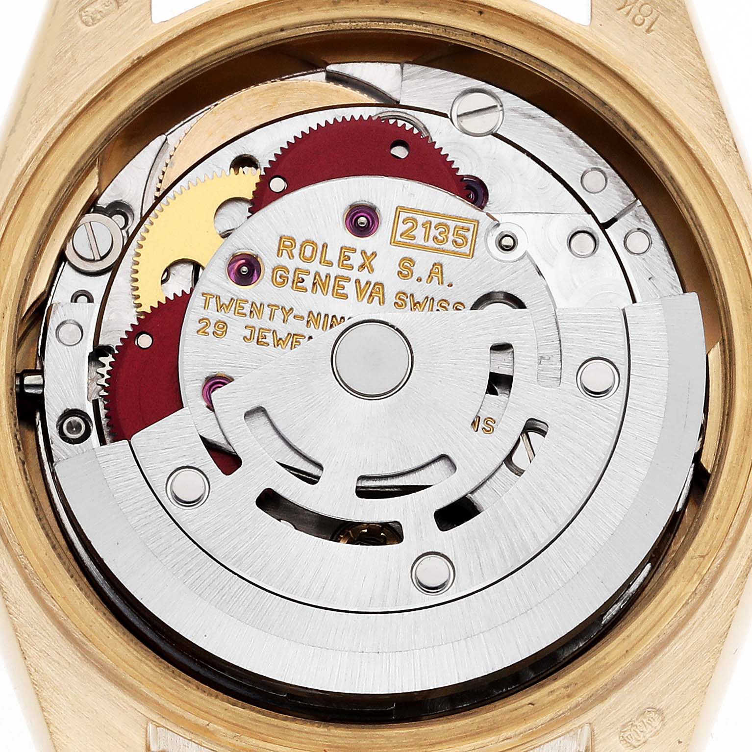 This image shows the movement of a Rolex President 69178 Women's Yellow Gold Champagne Dial 69178 Women's Yellow Gold Champagne Dial watch from the back, highlighting gears and inscriptions.