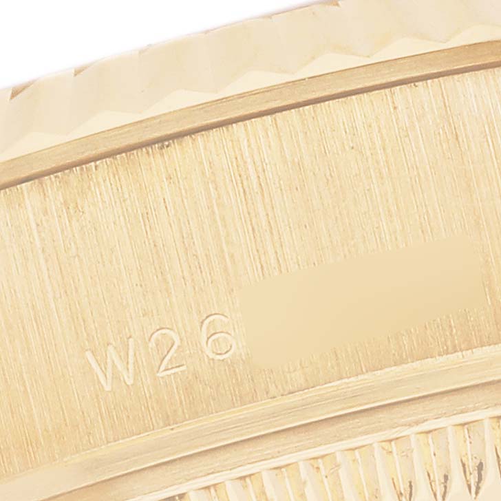 The image shows a close-up of the side of a Rolex President 69178 Women's Yellow Gold Champagne Dial 69178 Women's Yellow Gold Champagne Dial watch, displaying engraved details.
