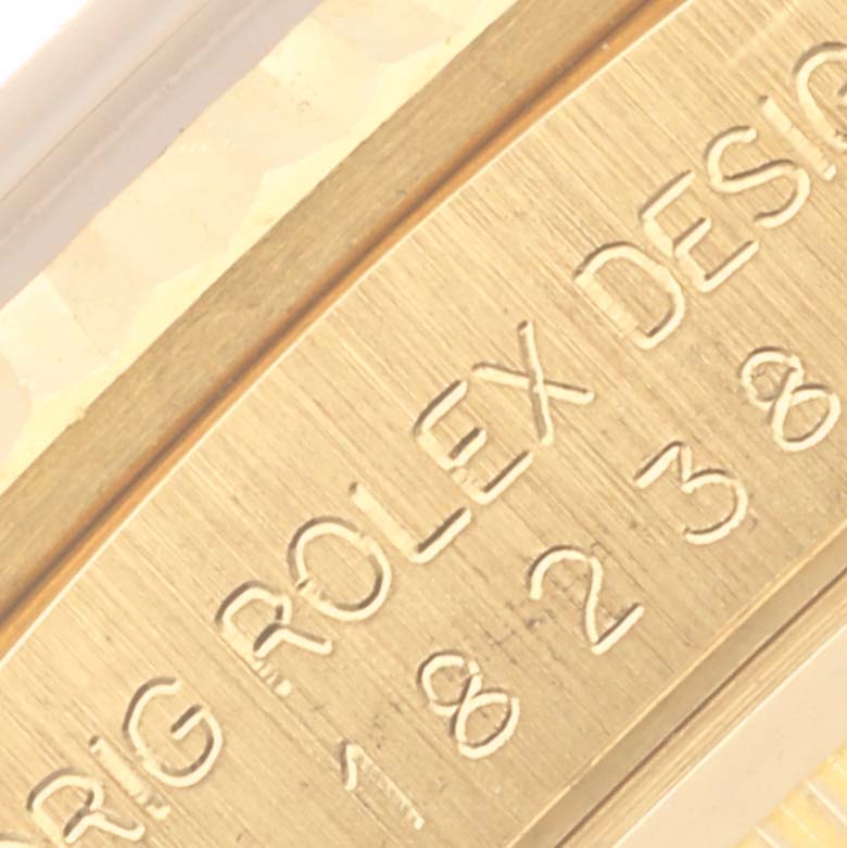 The image shows a close-up of the side engraving on a Rolex President 18238 Men's Yellow Gold Champagne Dial 18238 Men's Yellow Gold Champagne Dial model watch.