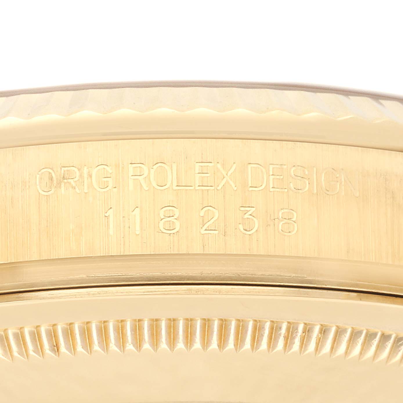 The image shows the side engraving on the bezel and case of a Rolex President 118238 Men's Yellow Gold White Dial 118238 Men's Yellow Gold White Dial model.